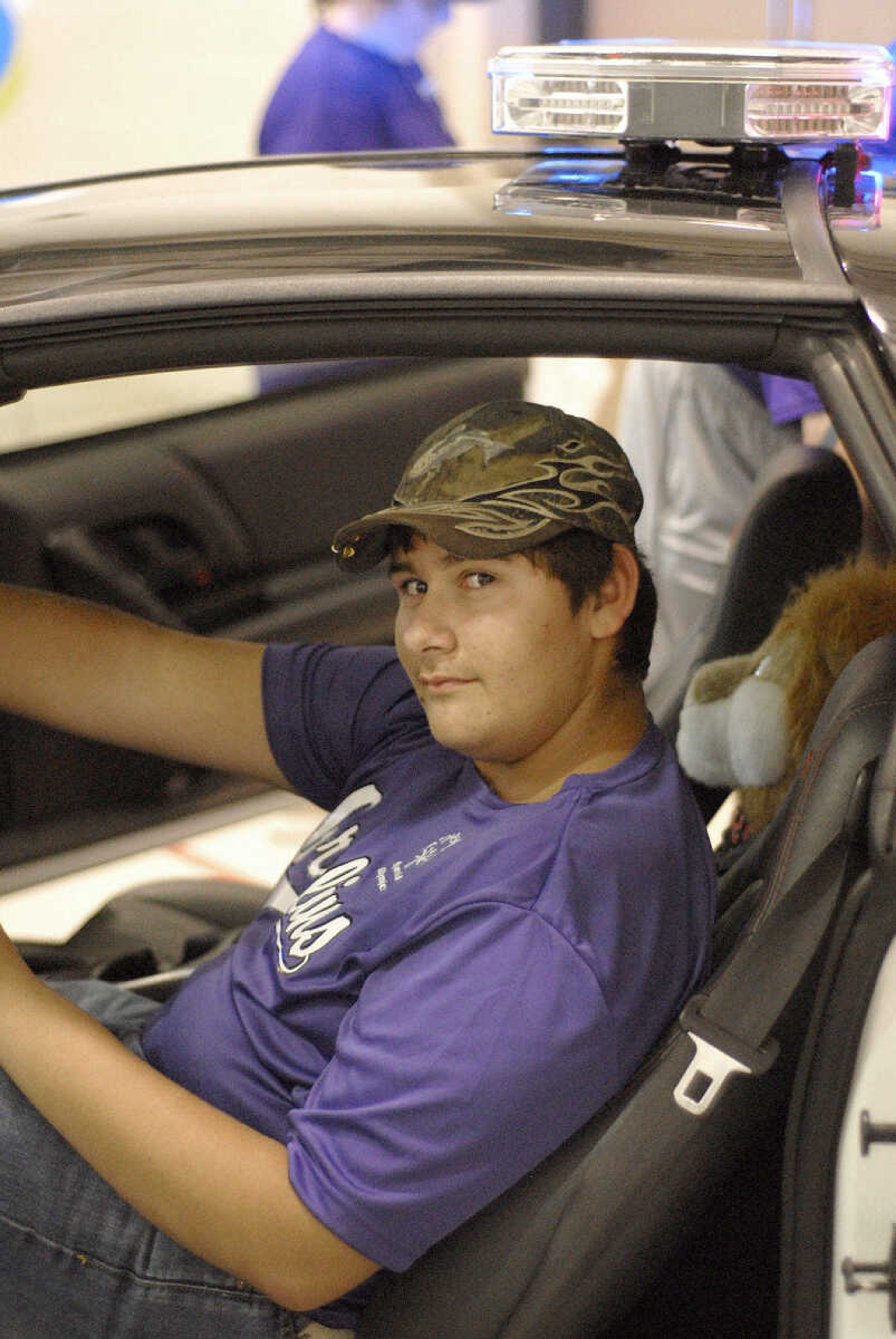 LAURA SIMON ~ lsimon@semissourian.com
William Hansel of Union, Mo. takes a seat inside the D.A.R.E. car at Victory Village inside the the Osage Centre Saturday, August 13, 2011 in Cape Girardeau.