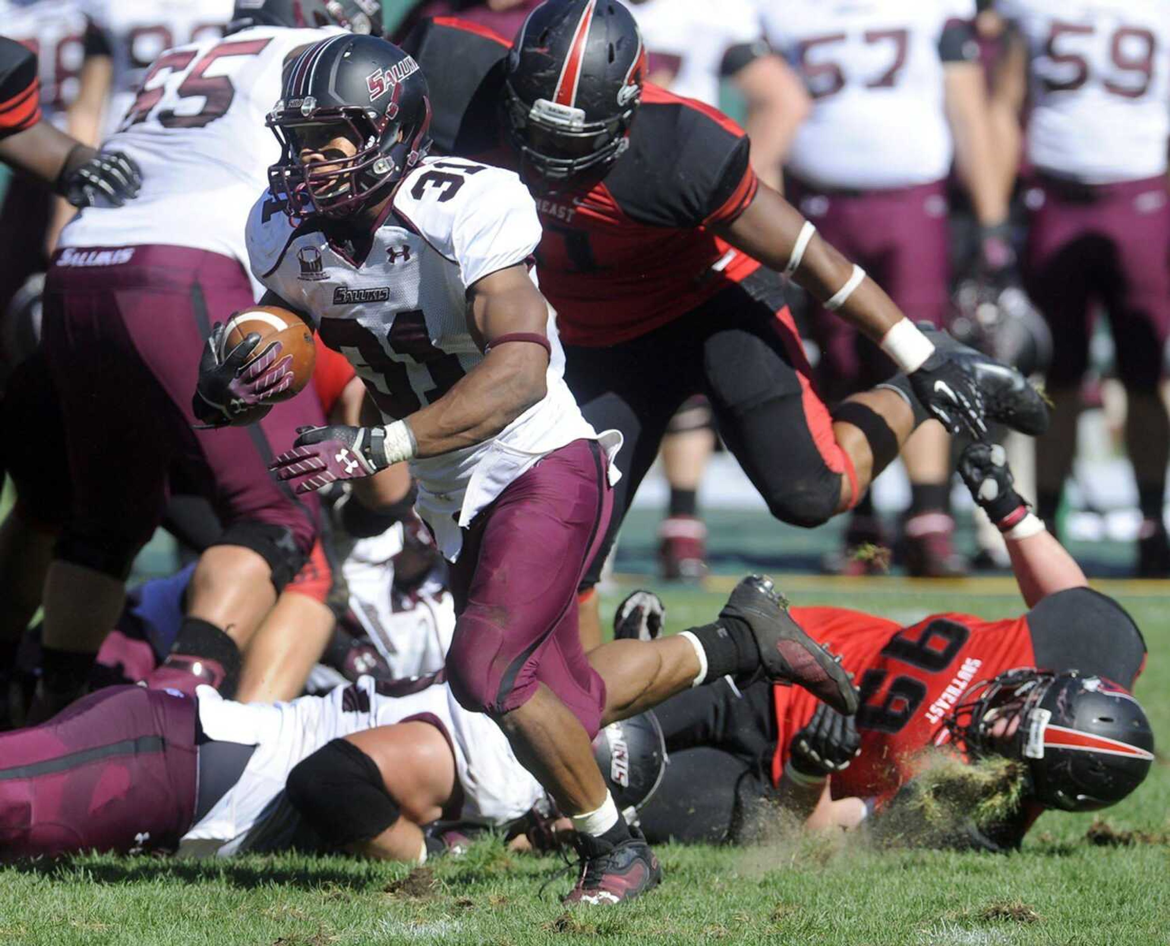 Southern Illinois running back Malcolm Agnew kicks up turf on Southeast Missouri State defender Austin Black during the fourth quarter.