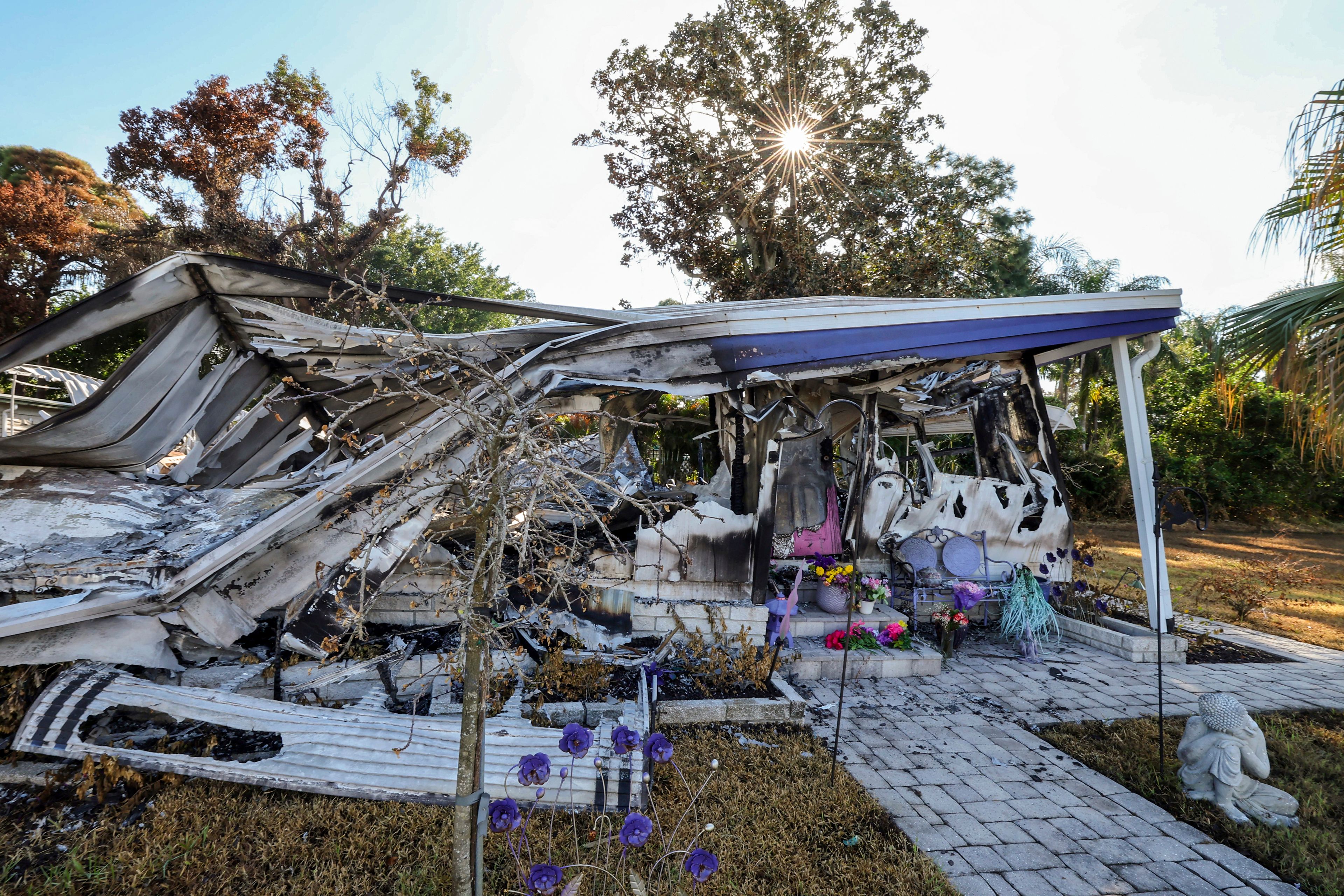 The remains of the home of Patricia Mikos who died when the home caught fire during Hurricane Helene as seen Wednesday, Oct. 2, 2024, in Dunedin, Fla. (AP Photo/Mike Carlson)