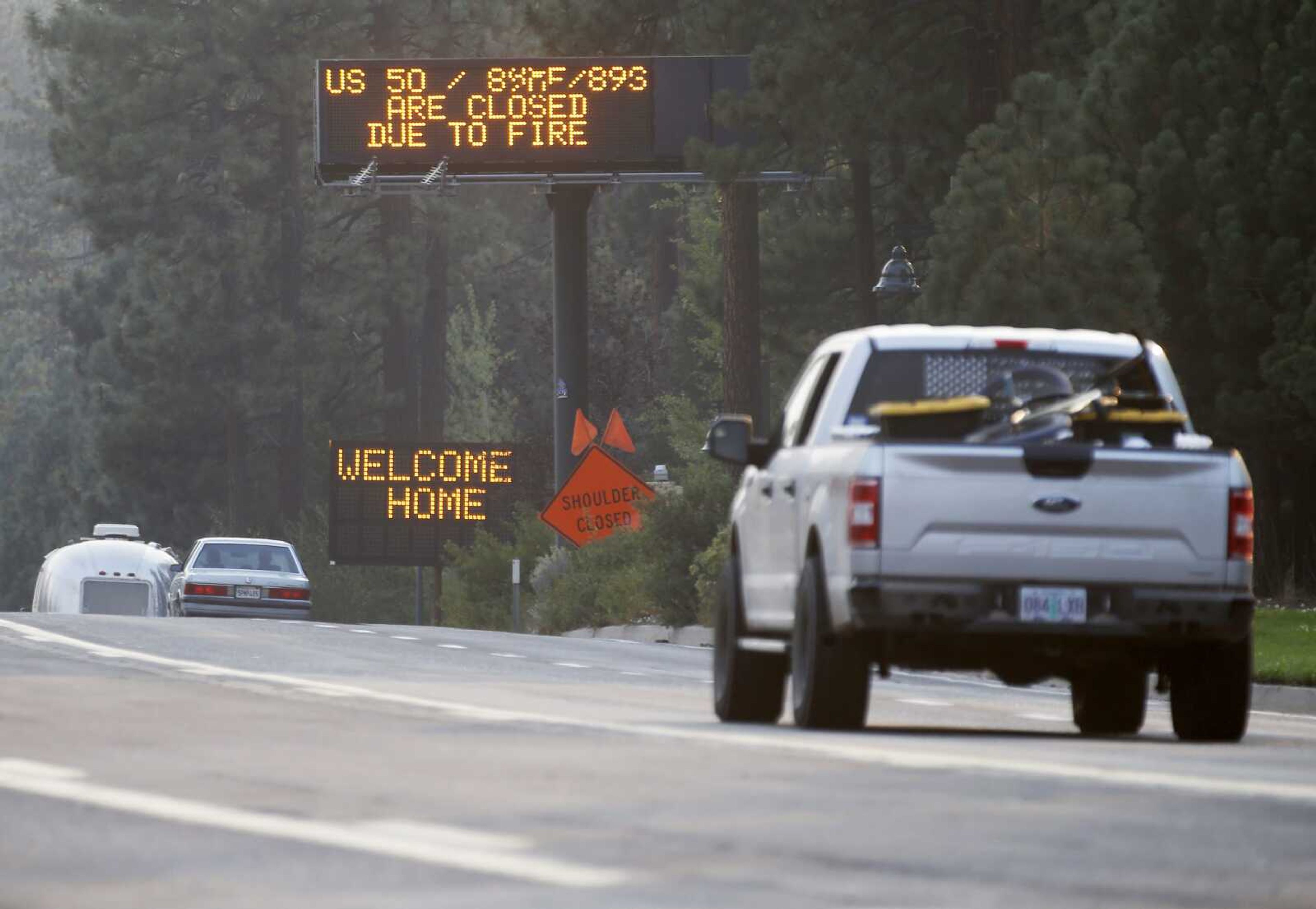 Traffic flows along Highway 50 on Sunday in South Lake Tahoe, California. Cal Fire officials downgraded some evacuation orders near Lake Tahoe and allowed thousands of South Lake Tahoe residents who fled the Caldor Fire last week to return home Sunday.