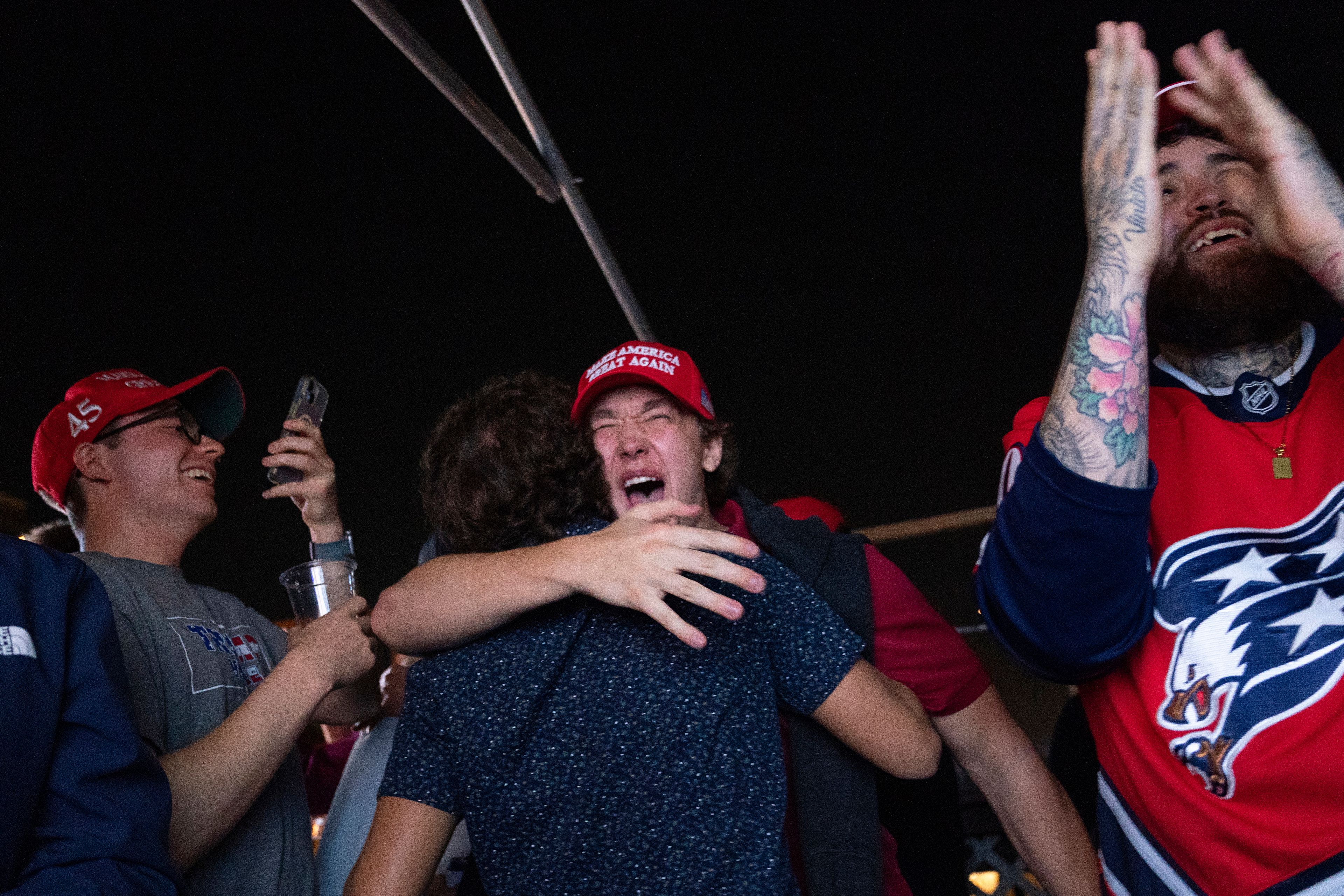 Supporters of Republican presidential nominee former President Donald Trump react to news that Trump won the state of Georgia during a watch party in Washington, Wednesday, Nov. 6, 2024. (AP Photo/Nathan Howard)