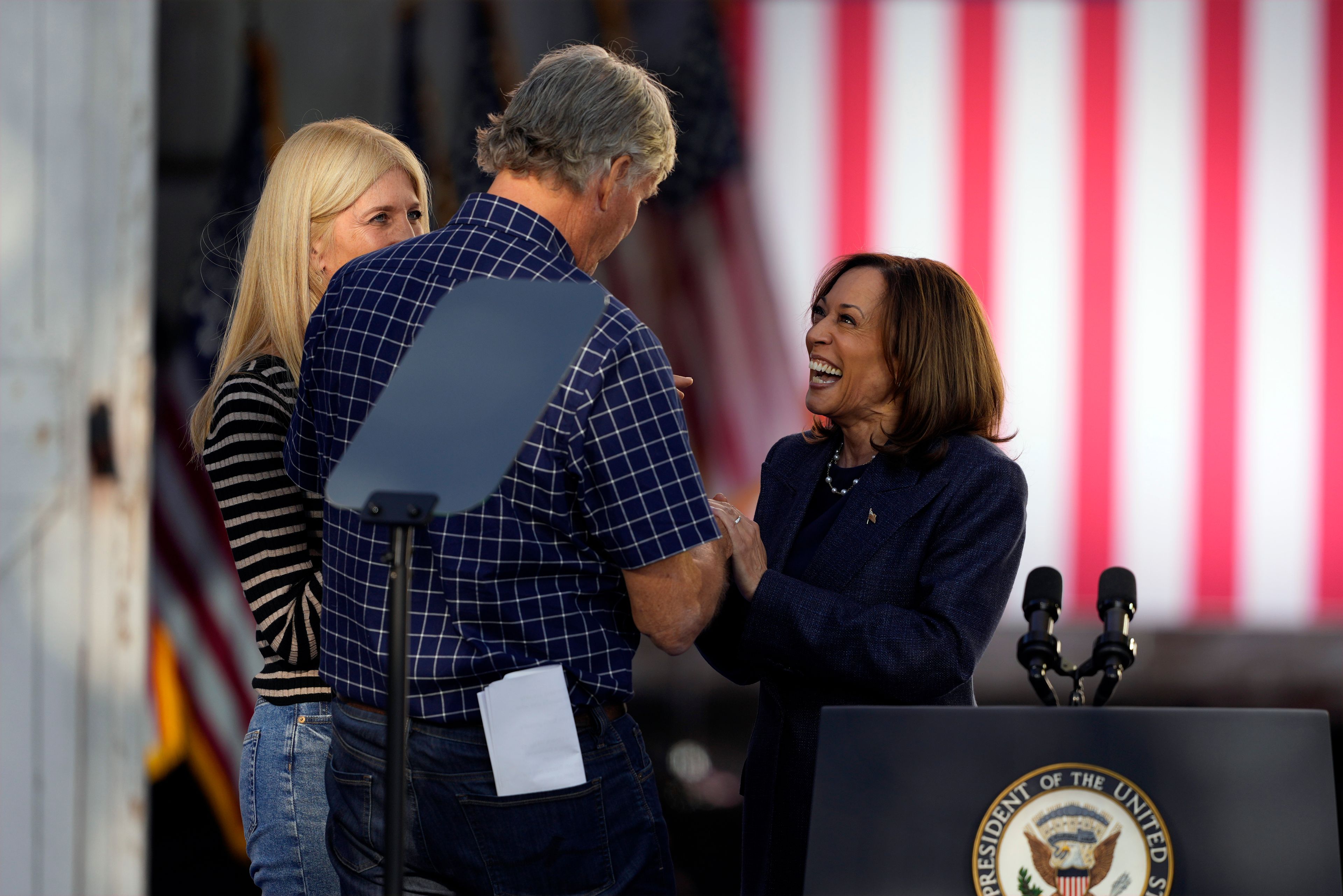 Democratic presidential nominee Vice President Kamala Harris talks with Bob and Christina Lang before speaking during a campaign event at Washington Crossing Historic Park, Wednesday, Oct. 16, 2024, in Washington Crossing, Pa. (AP Photo/Matt Slocum)