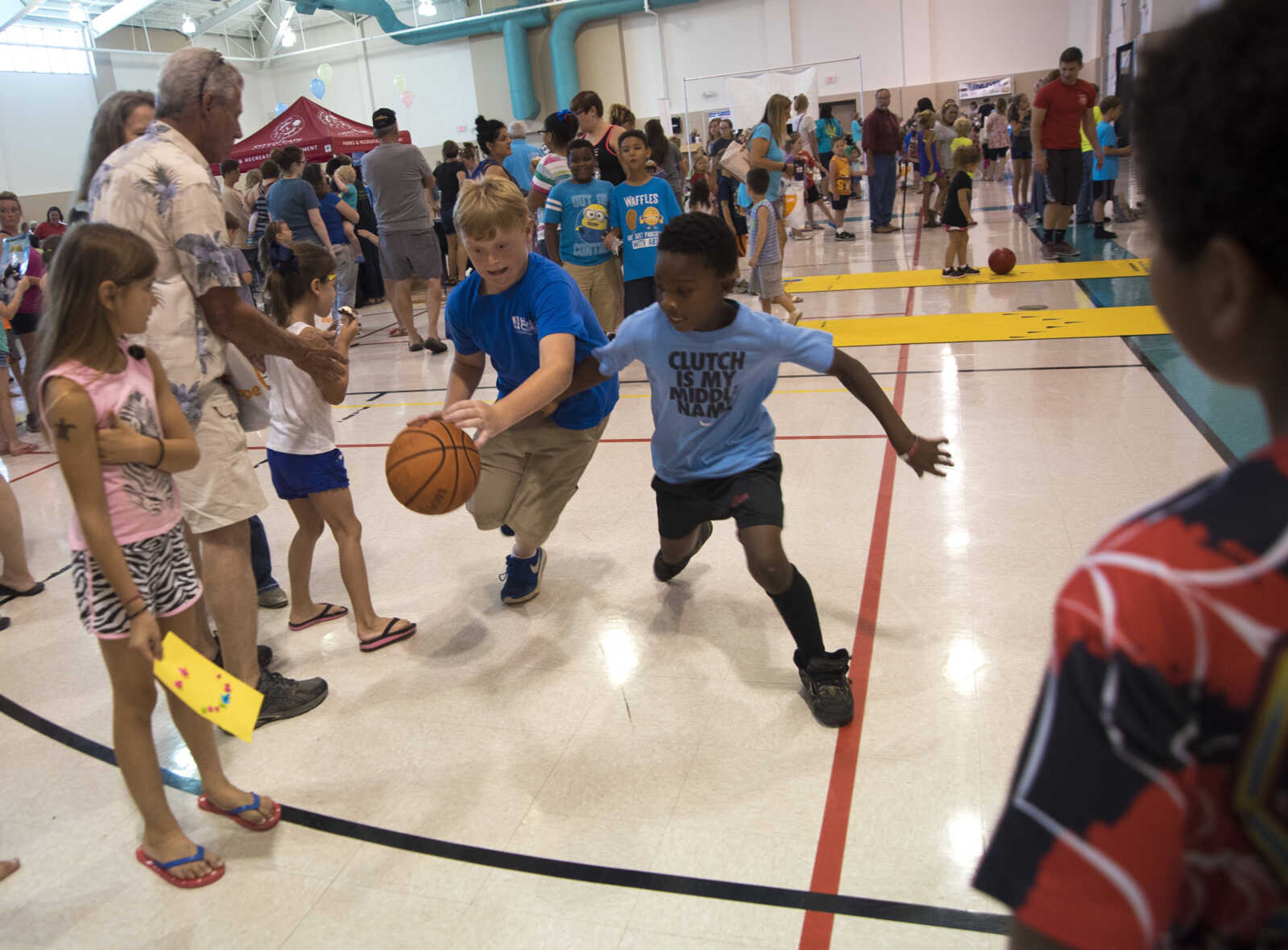 Tysen Sadler, left, dribbles the ball around Nate Tilson, right, while playing basketball during the Parks and Rec Day Friday, July 7, 2017 at the Osage Centre in Cape Girardeau.