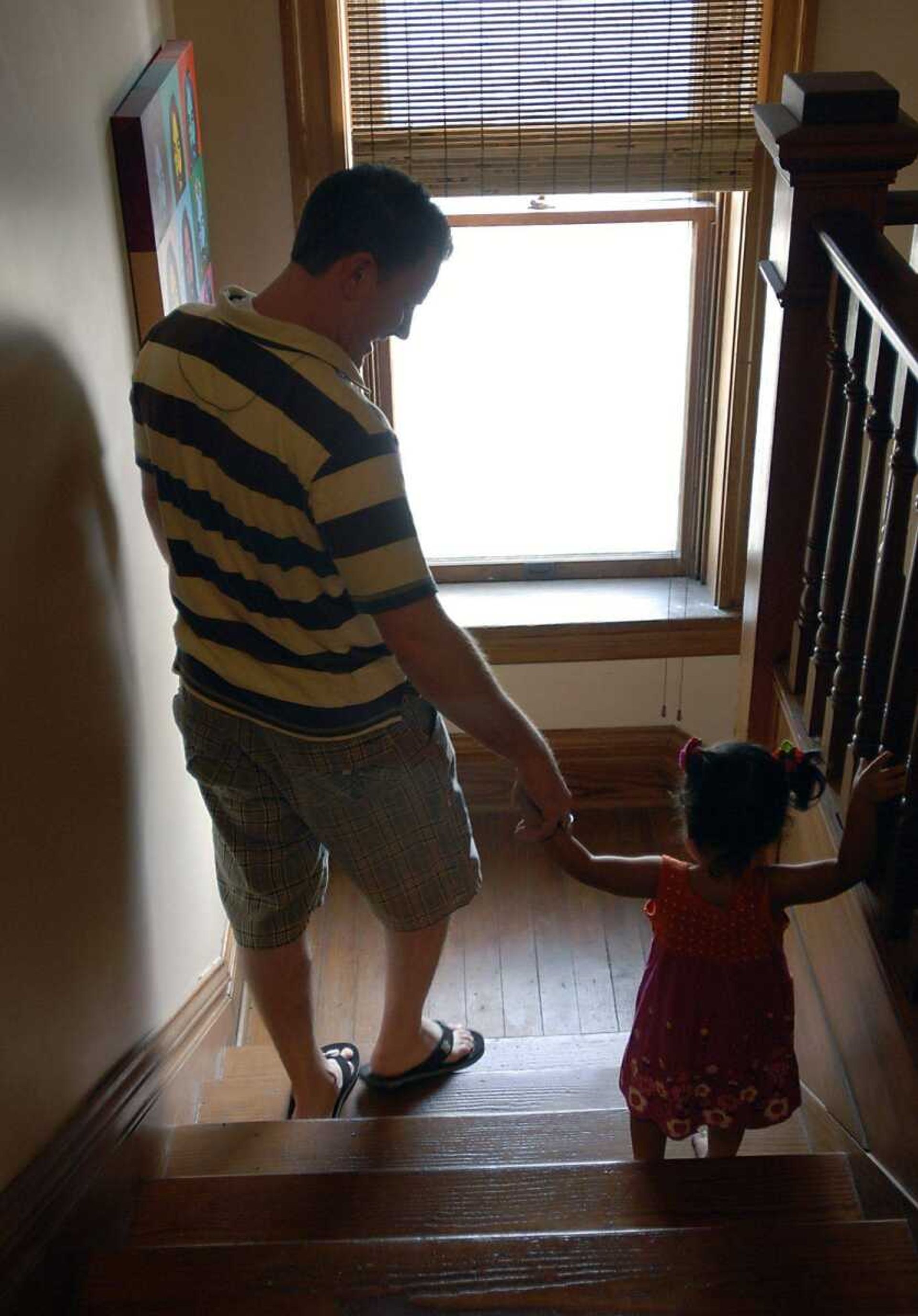 KIT DOYLE ~ kdoyle@semissourian.com
Eric Becking helped his daughter Bianca navigate the stairs Thursday morning, August 21, 2008, in their Cape Girardeau home.