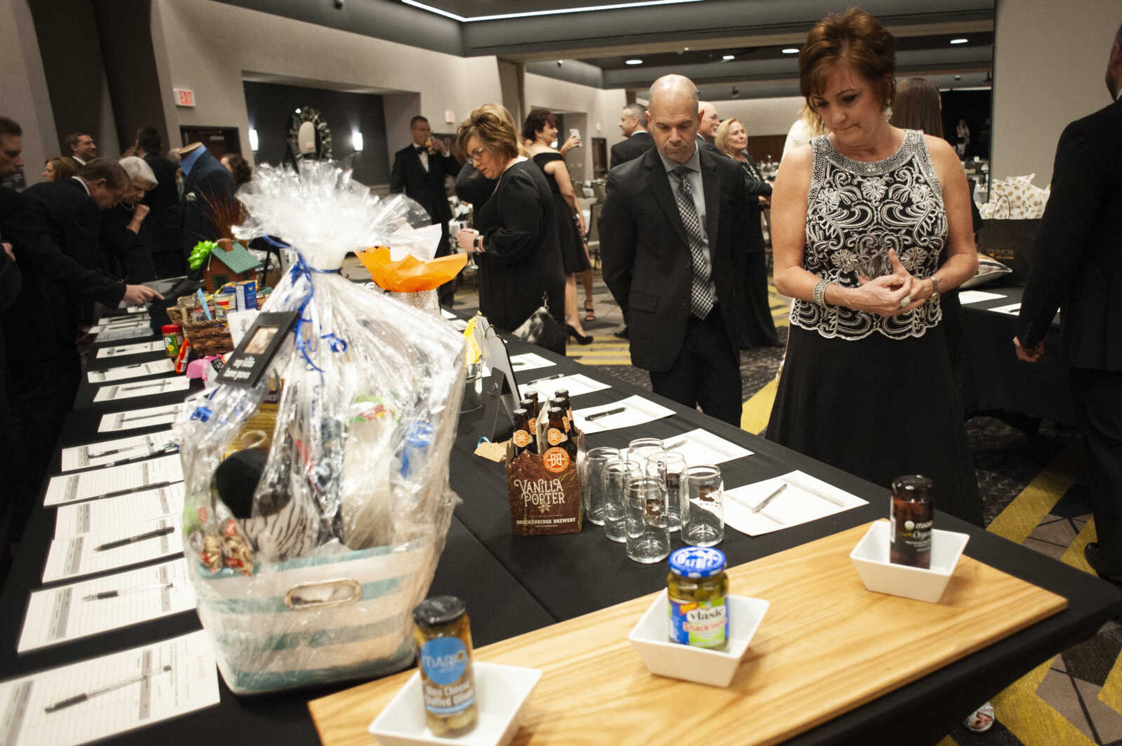 Melanie and Tim Gutwein of Cape Girardeau look at auction items during the 13th annual Penguin Party on Feb. 9, 2019, at Drury Plaza Hotel Conference Center in Cape Girardeau. The event supports Cape Girardeau public schools.