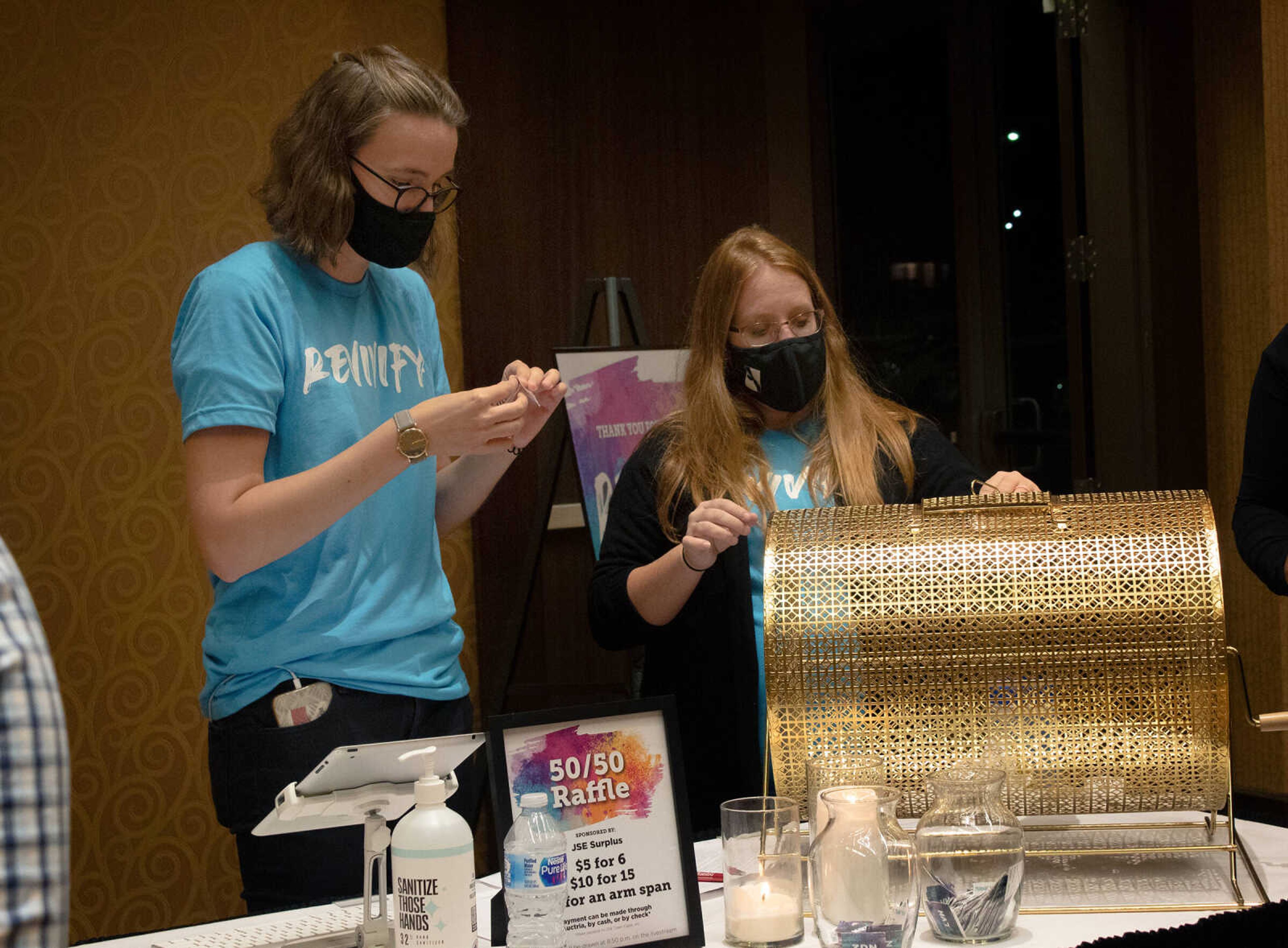 Revivify workers Marlen Hoedebeck (left) and Kaitlyn Kraus prepare to raffle items at Old Town Cape's Revivify fundraiser on Thursday, Oct. 22, 2020, at Century Casino in Cape Girardeau.