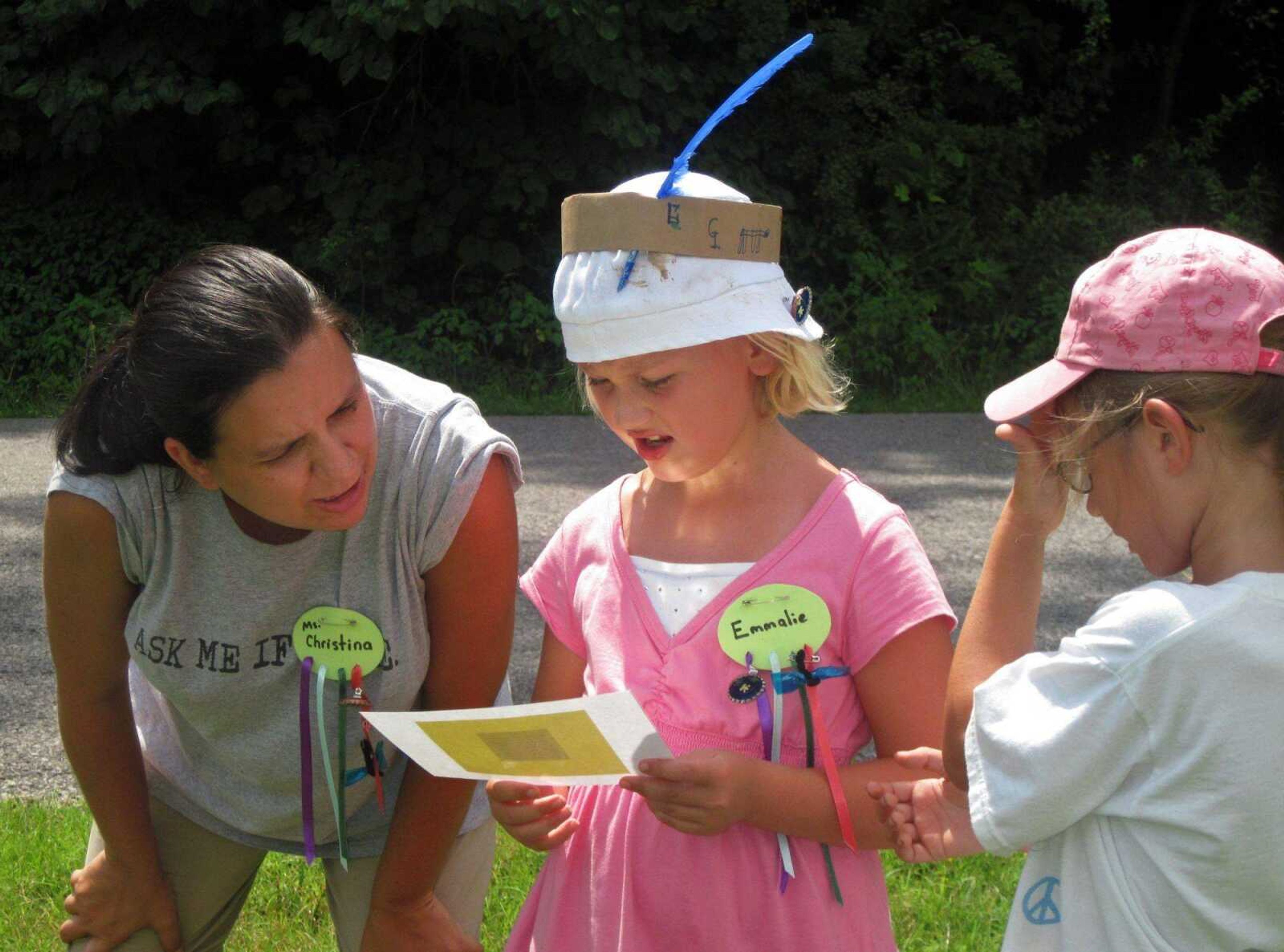 Camp volunteer Christina Jones, left, helps Emmalie Wooden, center, and Haylee Quatmann, right, read a map while playing a game at the weeklong Girl Scout day camp at Trail of Tears State Park on Thursday, July 15, 2010. (CARRIE BARTHOLOMEW)