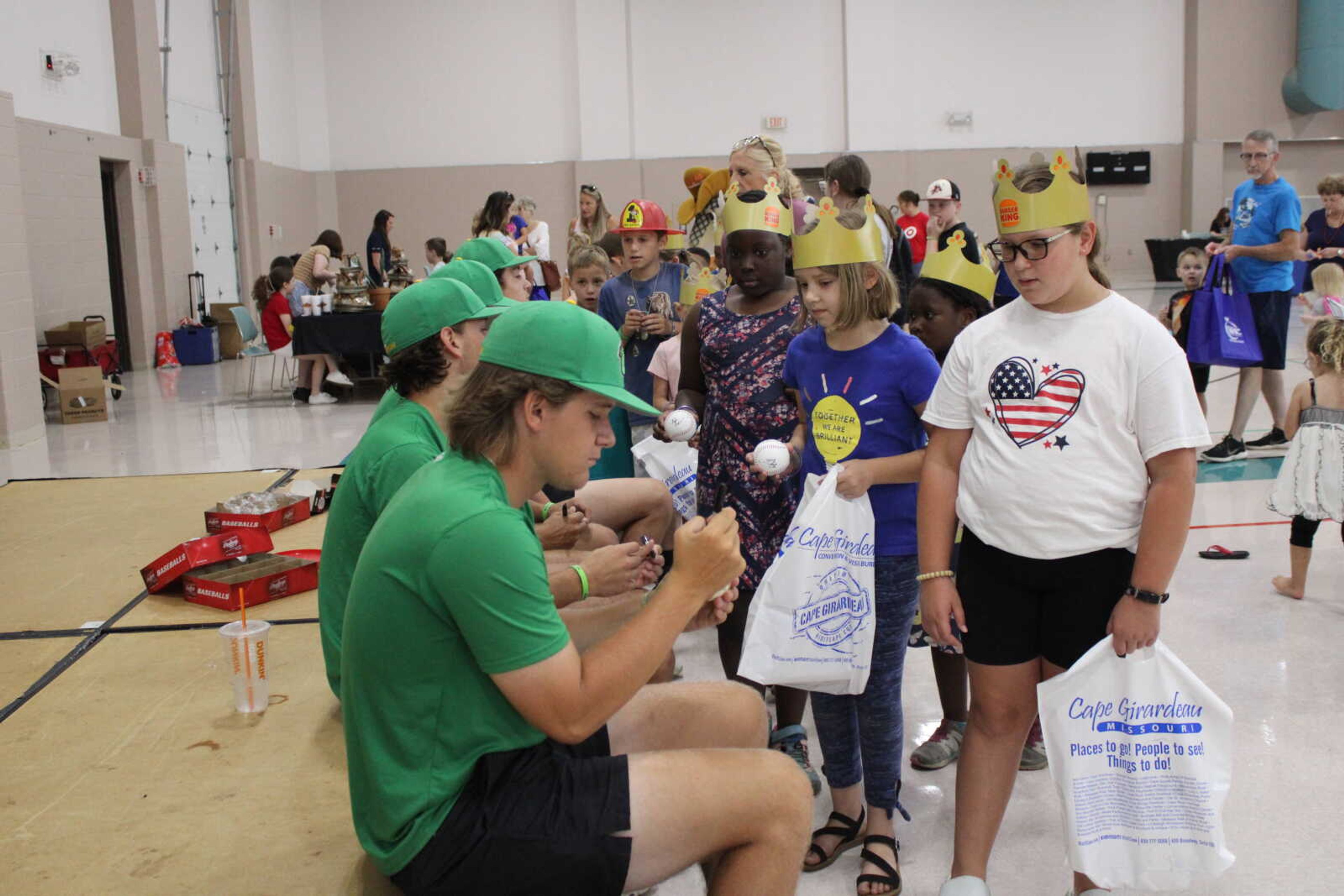 Cape Catfish players sign baseballs for those who attended the Parks and Rec day.