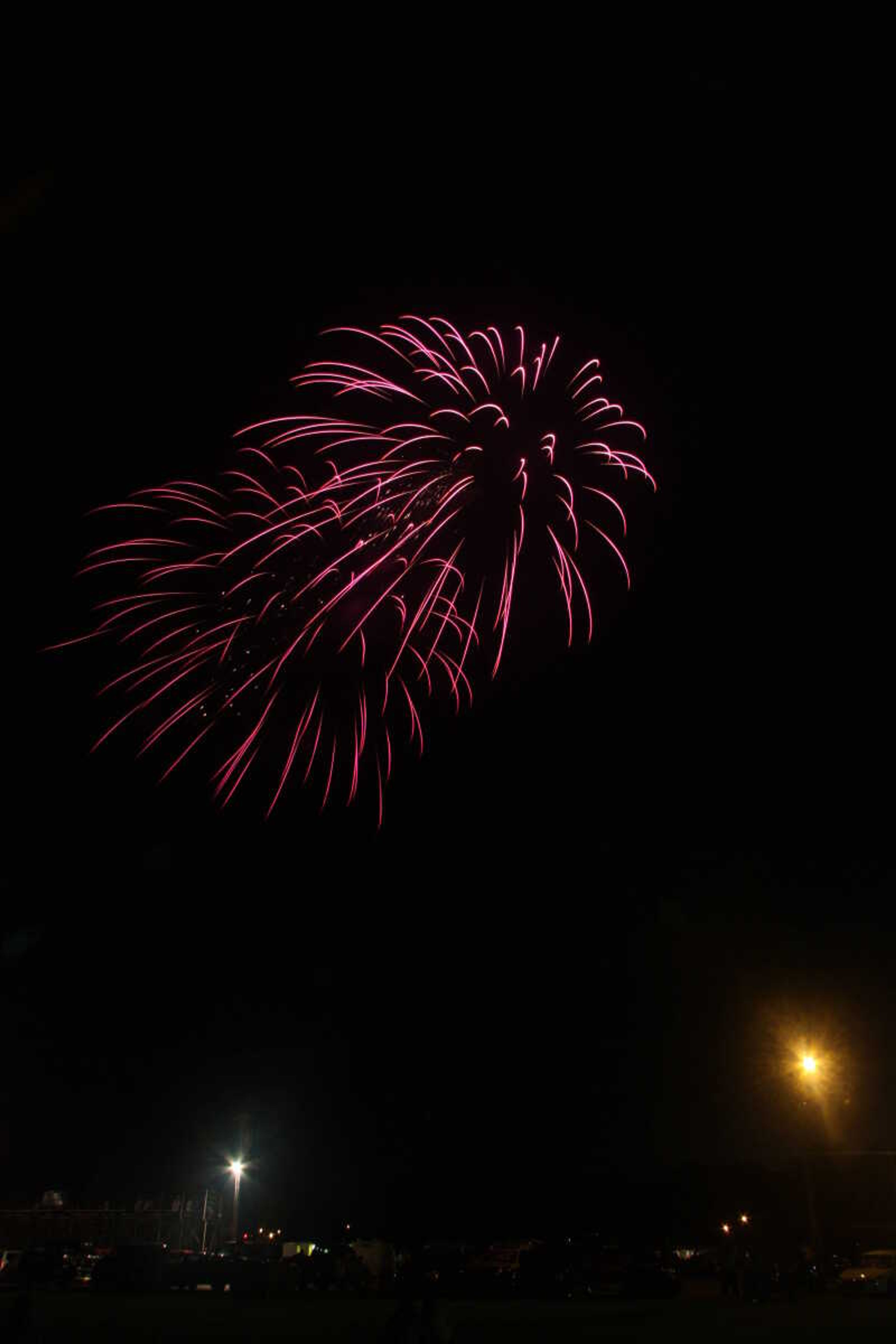 Picture of the fireworks display in Cape Girardeau's Arena Park, taken from a field south of the park.