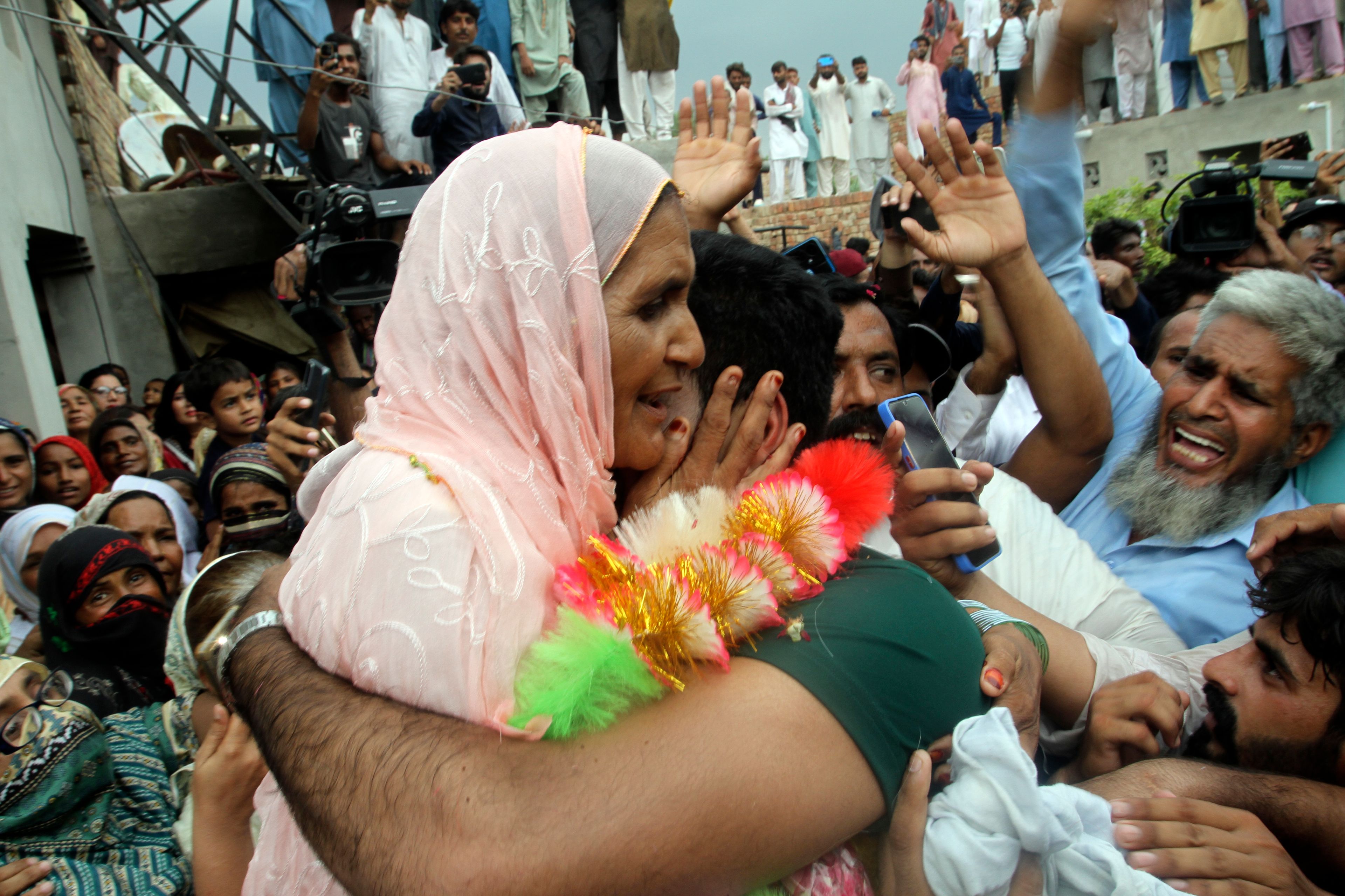 Men's javelin gold medalist, Arshad Nadeem, of Pakistan Arshad Nadeem hugs his mother outside his house, in Mian Channu, Khanewal district, of Pakistan, Sunday, Aug. 11, 2024. (AP Photo/Asim Tanveer)