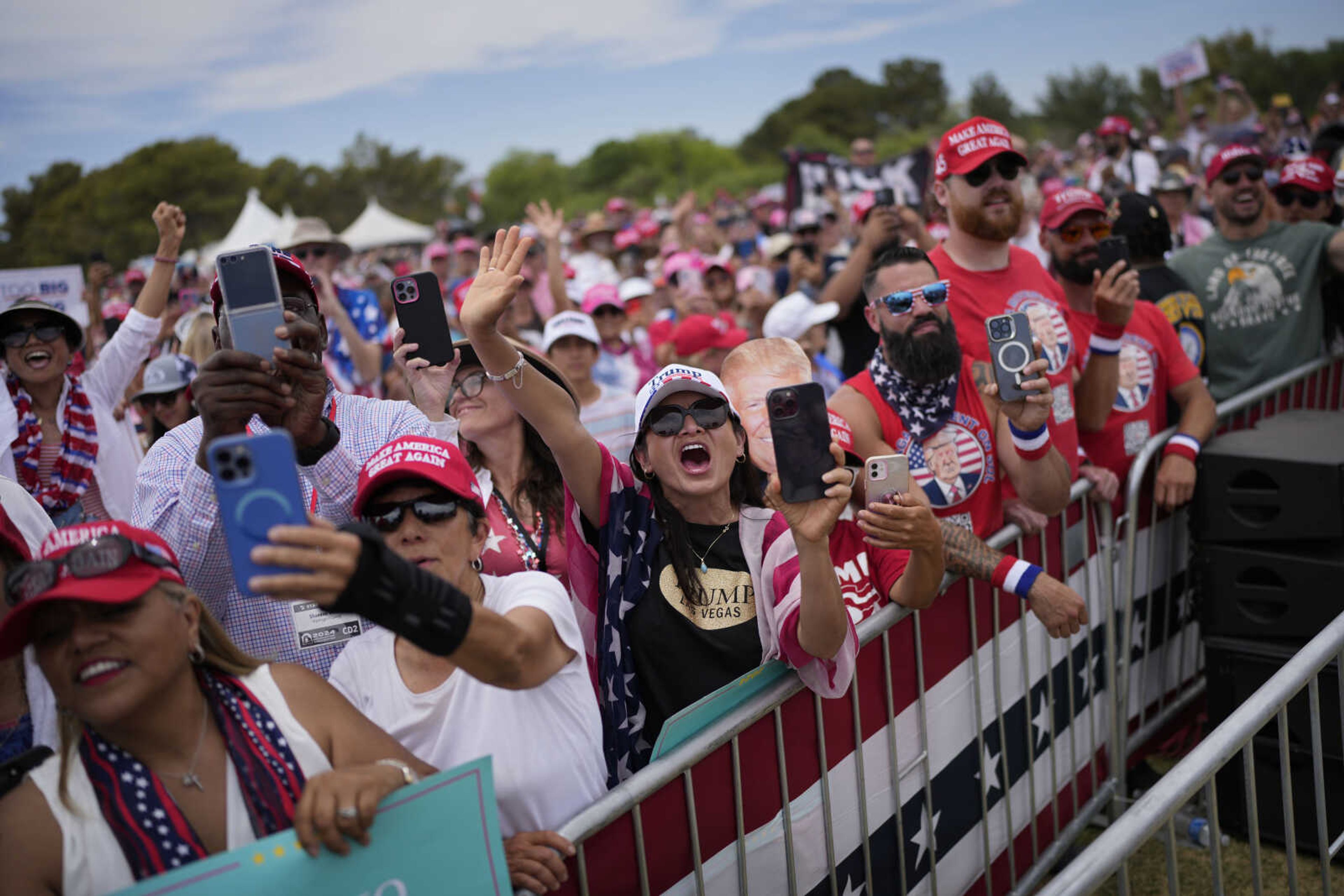 People cheer as Republican presidential candidate former President Donald Trump speaks at a campaign rally Sunday in Las Vegas.