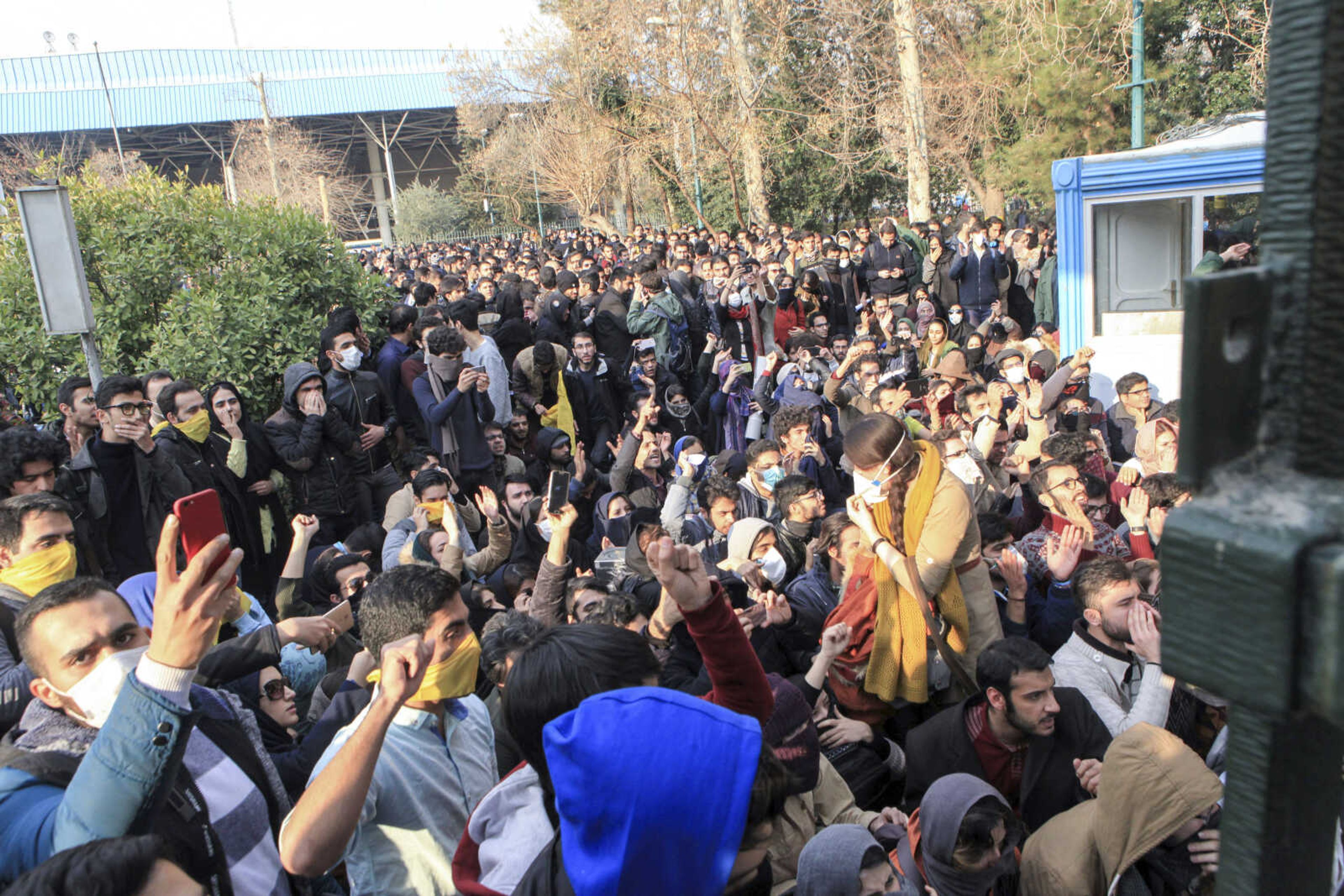 In this photo taken by an individual not employed by the Associated Press and obtained by the AP outside Iran, university students attend a protest inside Tehran University while anti-riot Iranian police prevent them from joining other protesters Saturday in Tehran, Iran. A wave of spontaneous protests over Iran's weak economy swept into Tehran on Saturday, with college students and others chanting against the government just hours after hard-liners held their own rally in support of the Islamic Republic's clerical establishment.