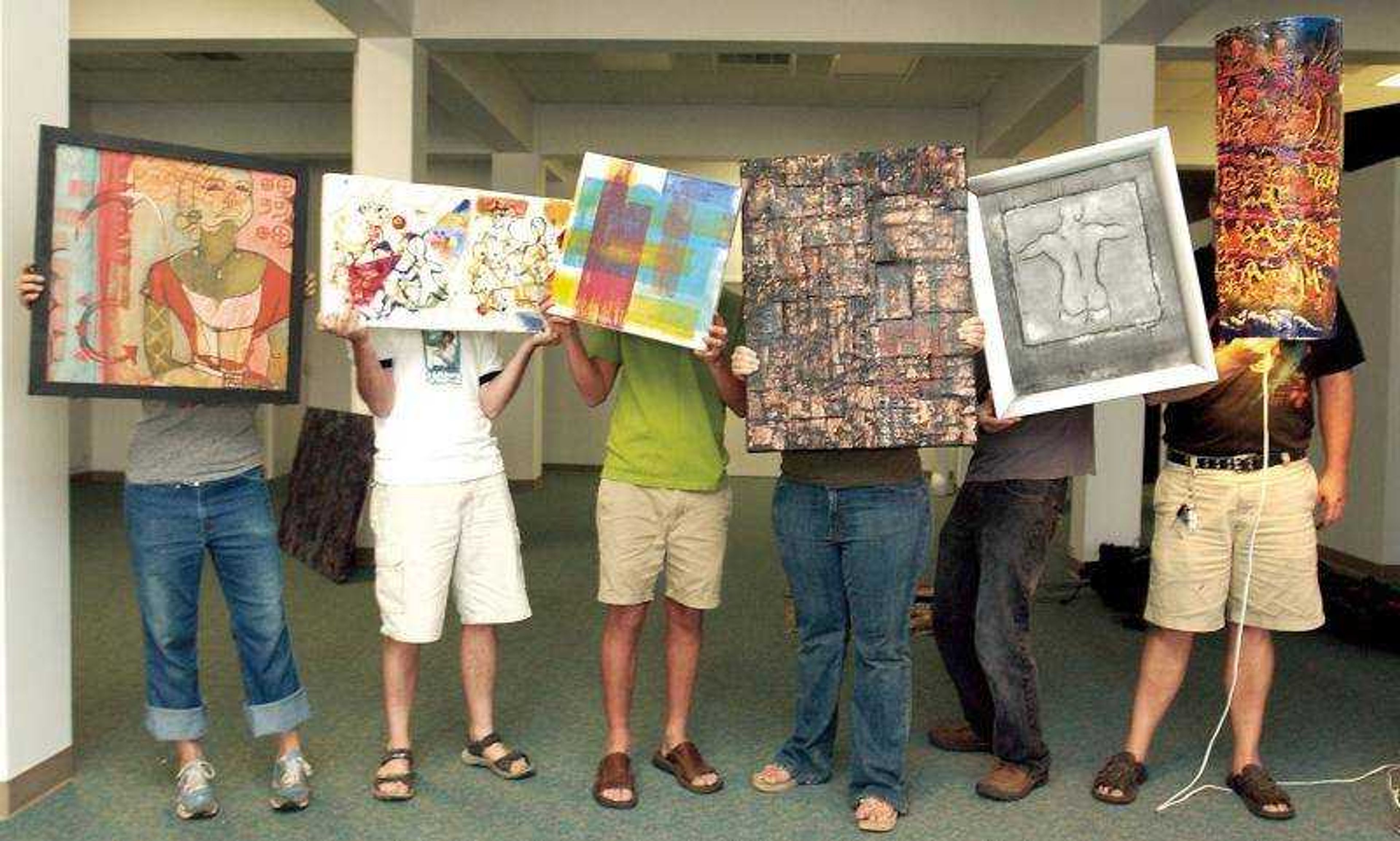 Local artists, from left, Megan Thrower, Dennis Wilson, Kristopher Naeger, Lindsey Baker, Charlie Kent and Harry McDaniel held up their creations Thursday.