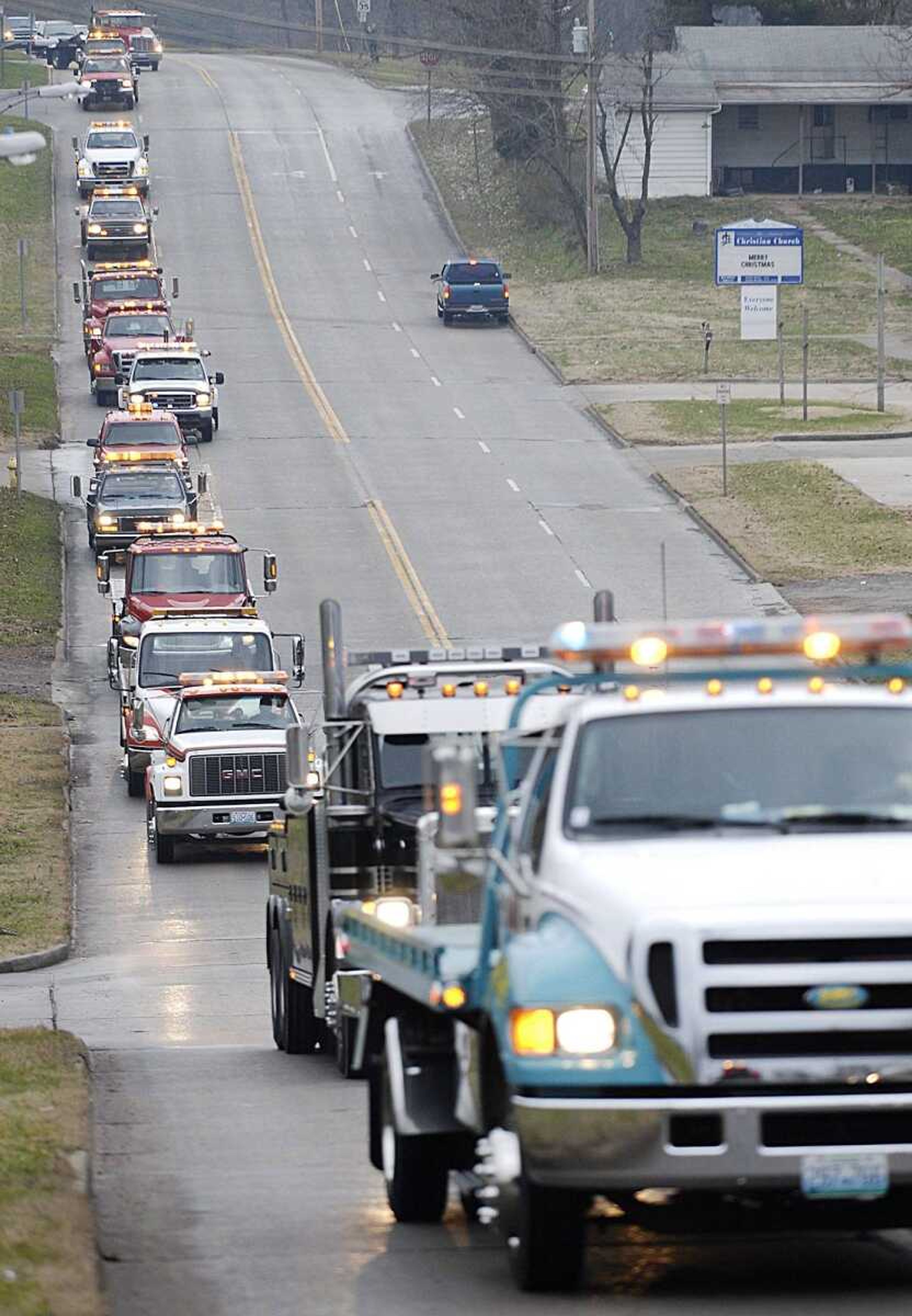 Twenty-nine tow trucks made their way down Mount Auburn Road as part of the funeral procession Thursday for Gary Sperling, owner of Sperling Garage and Wrecker Servic.  Towing companies from across the region brought trucks to pay their respects. (Aaron Eisenhauer)