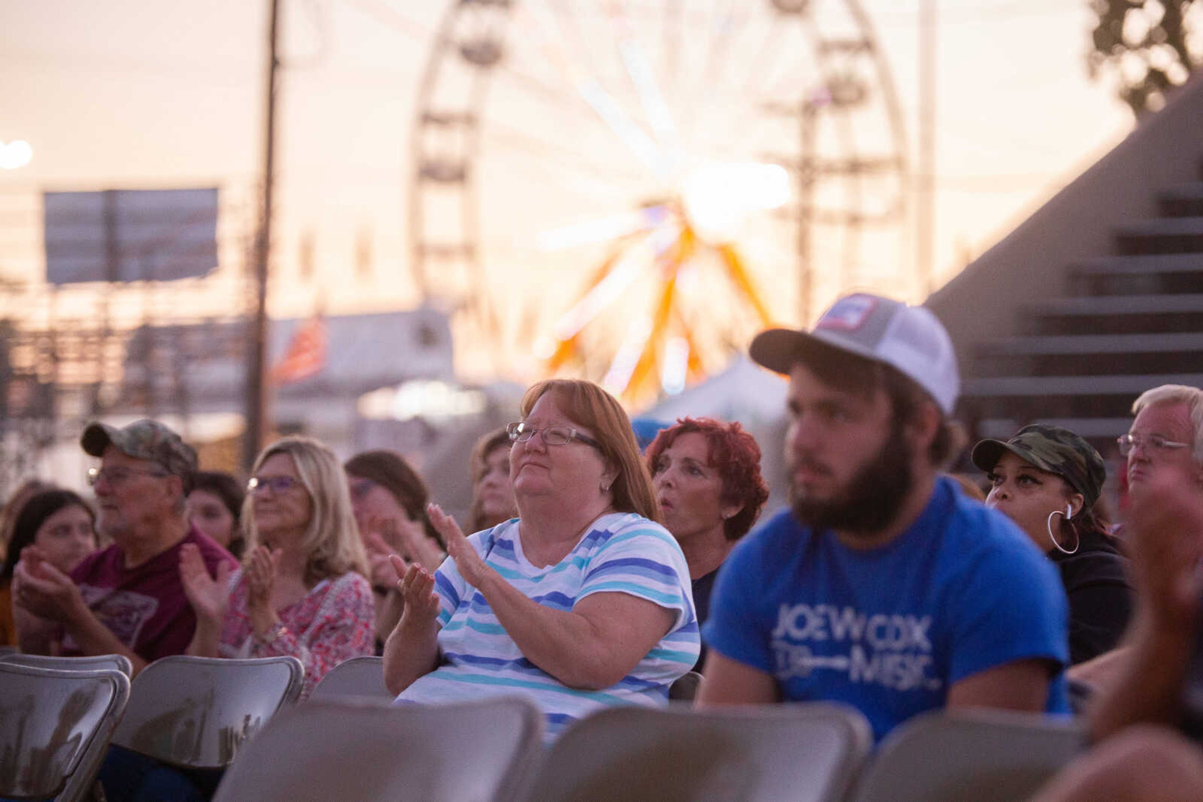 Fairgoers clap as they watch the the Heartland Idol Finals competition on Monday, Sept. 12 at the SEMO District Fair in Cape Girardeau.