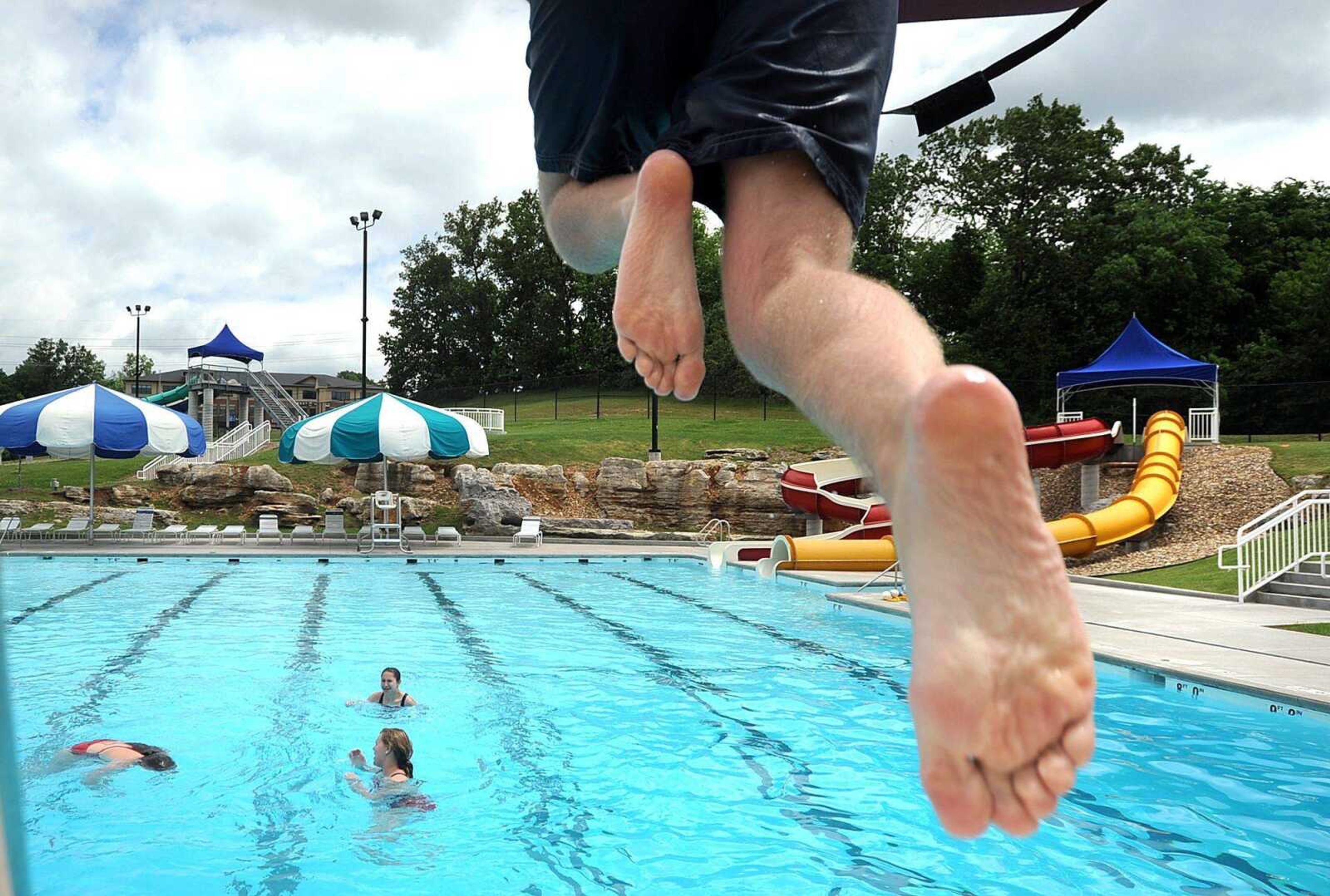 Ryan May jumps into the pool from his lifeguard tower Thursday at Cape Splash in Cape Girardeau. May was training in passive extraction as part of his water park certification. May already has his lifeguard certification. Each person had to play the part of primary and secondary responder, as well as the passive role, which means acting unconscious, during their training. (Laura Simon)