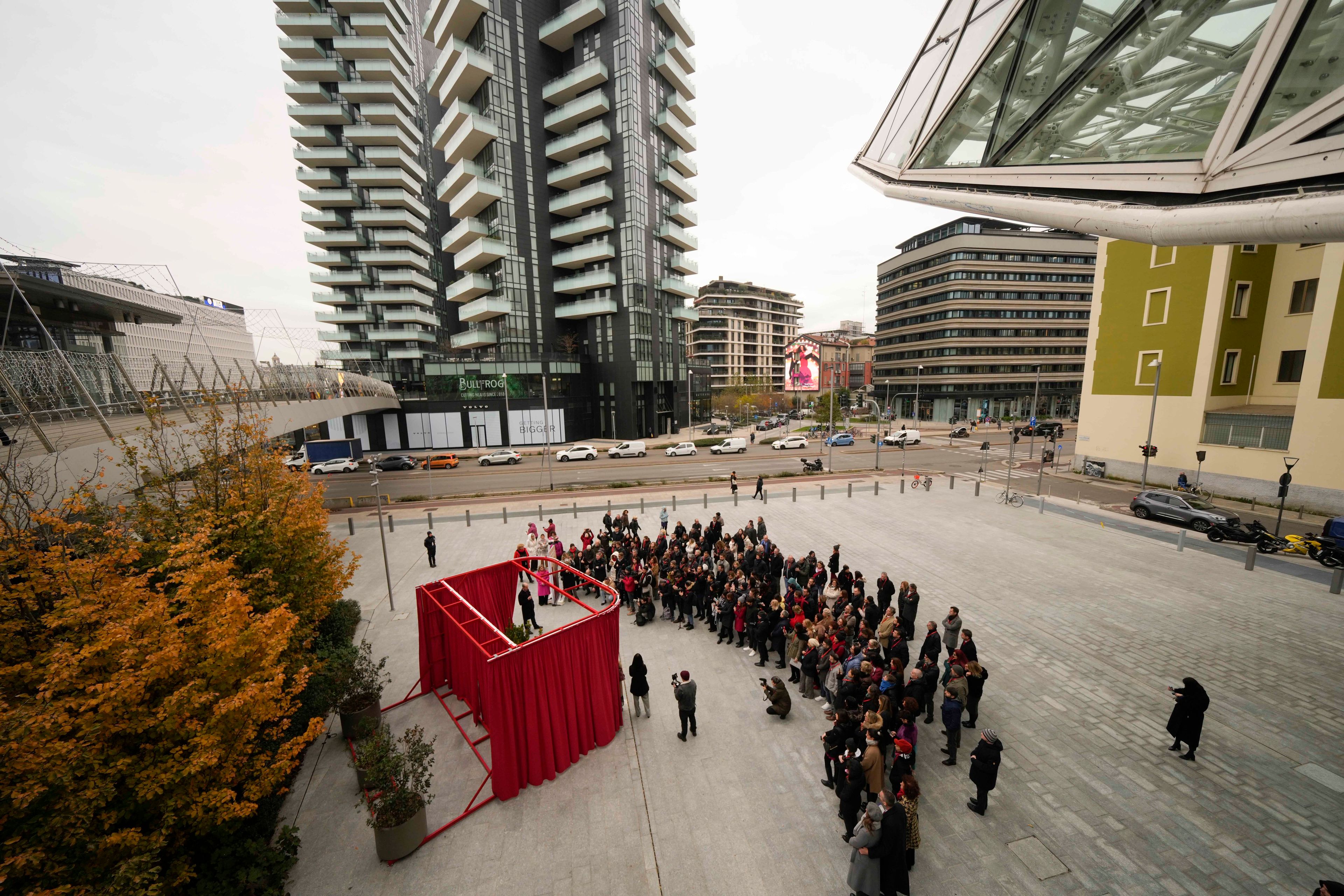 People participate in the unveiling of a red bench on the occasion of the International Day for the Elimination of Violence against Women, in Milan, Italy, Monday, Nov. 25, 2024. (AP Photo/Luca Bruno)