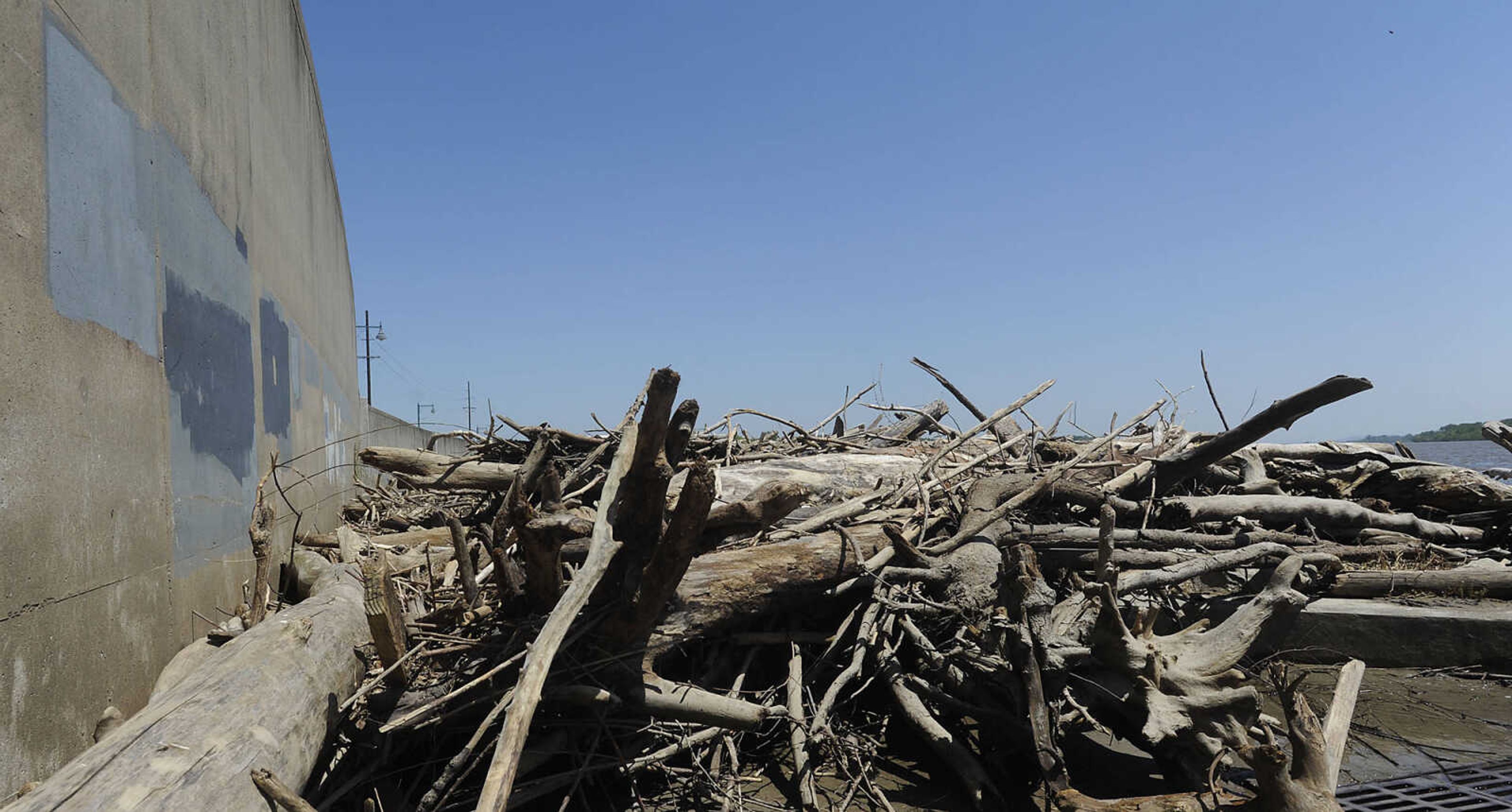 Debris and mud cover the walking path at Riverfront Park Wednesday, May 15, in Cape Girardeau. The Broadway floodgate has been opened but the floodgate at Themis Street remains closed.