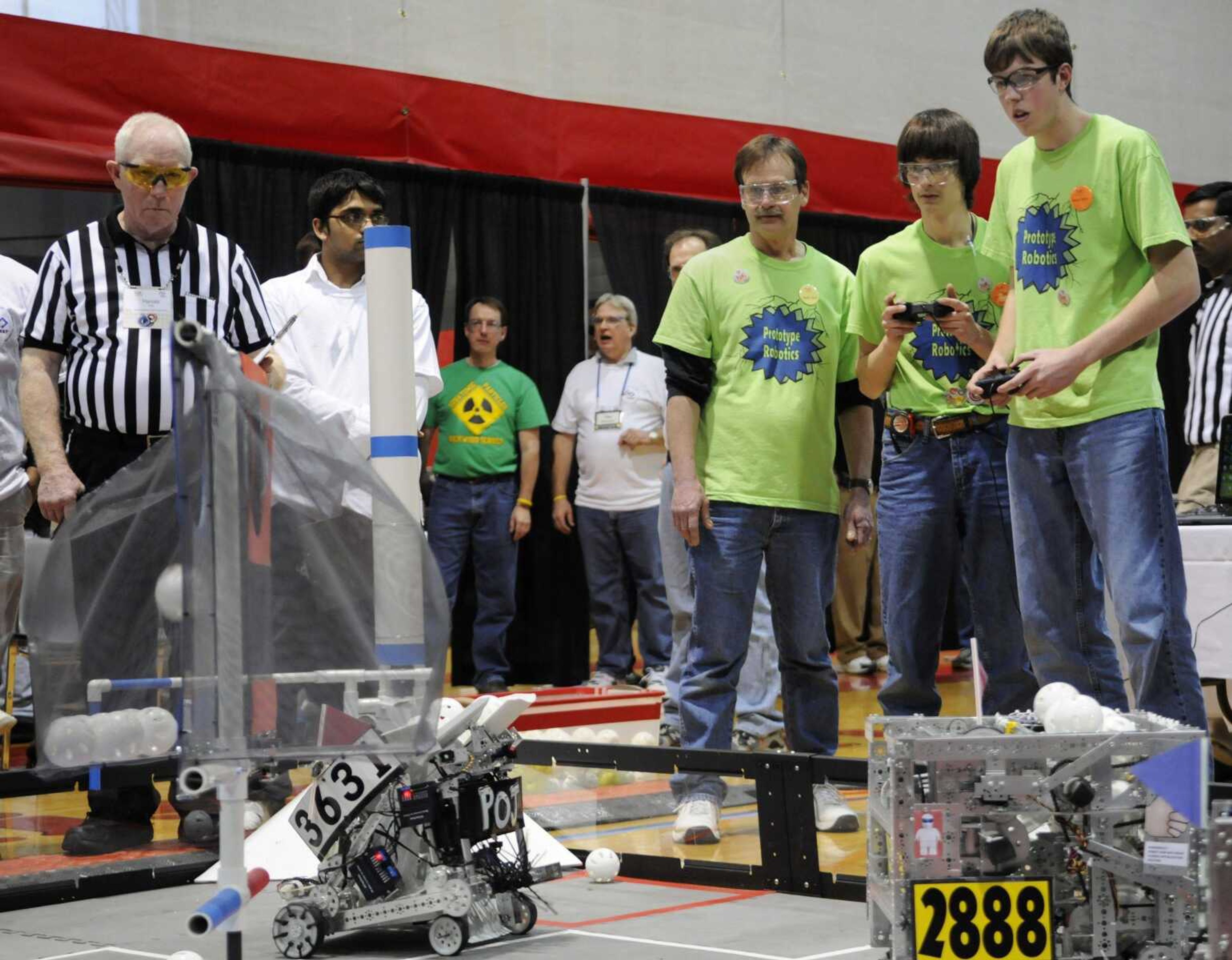 Team mentor Brian Criddle, Camden Criddle and Jon Eftink, members of the team Prototype Robotics, compete Saturday in the final round of the FIRST Tech Challenge Competition at Southeast Missouri State University. The team made it to the final round in the competition. (KRISTIN EBERTS)