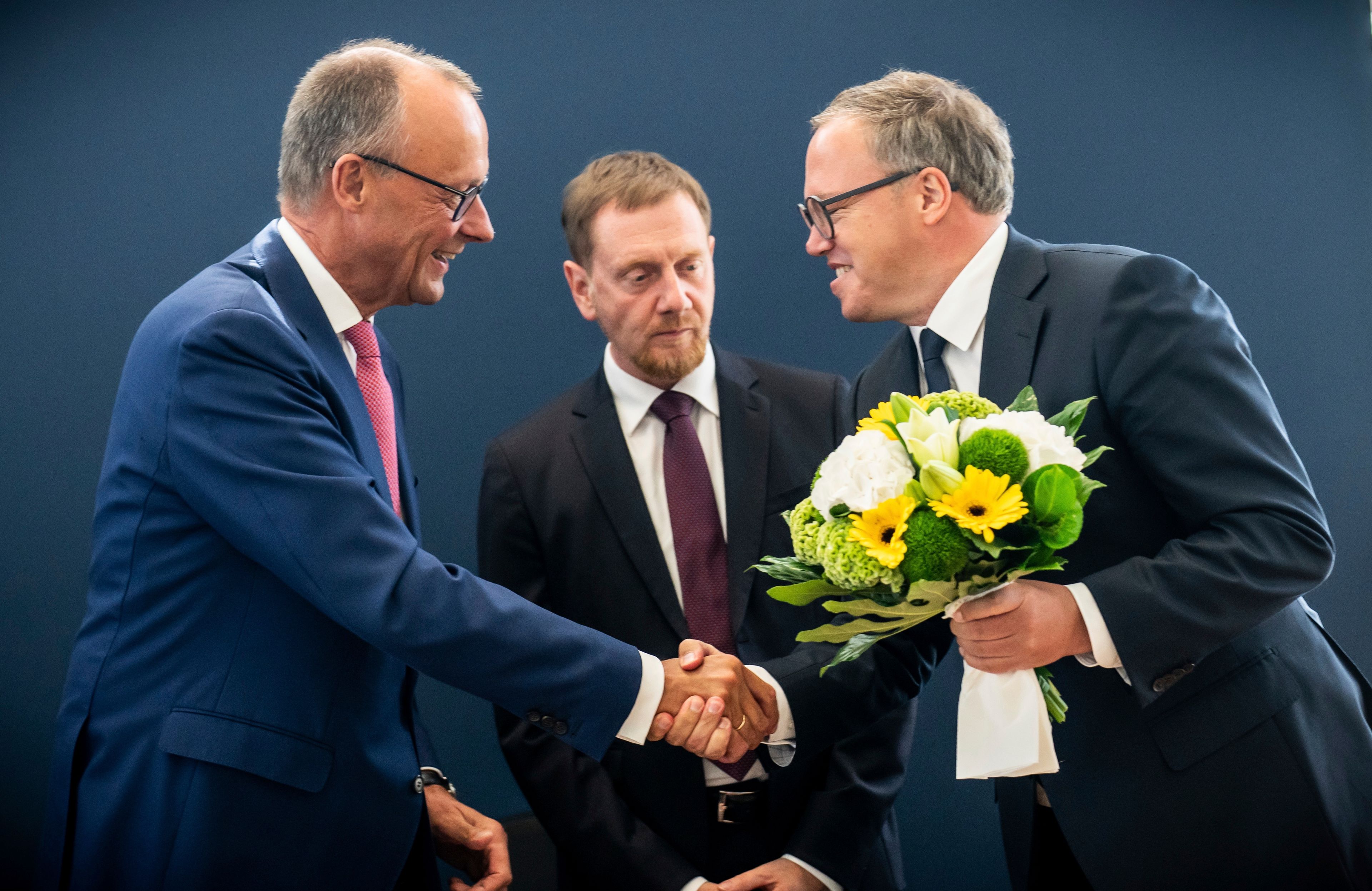 From left: Friedrich Merz, CDU federal chairman and CDU/CSU parliamentary group leader in the Bundestag, Michael Kretschmer (CDU), Minister President of Saxony and Mario Voigt, CDU state chairman in Thuringia, attend the CDU committee meeting following the state elections in Saxony and Thuringia, in Berlin, Monday, Sept. 2, 2024. (Michael Kappeler/dpa via AP)