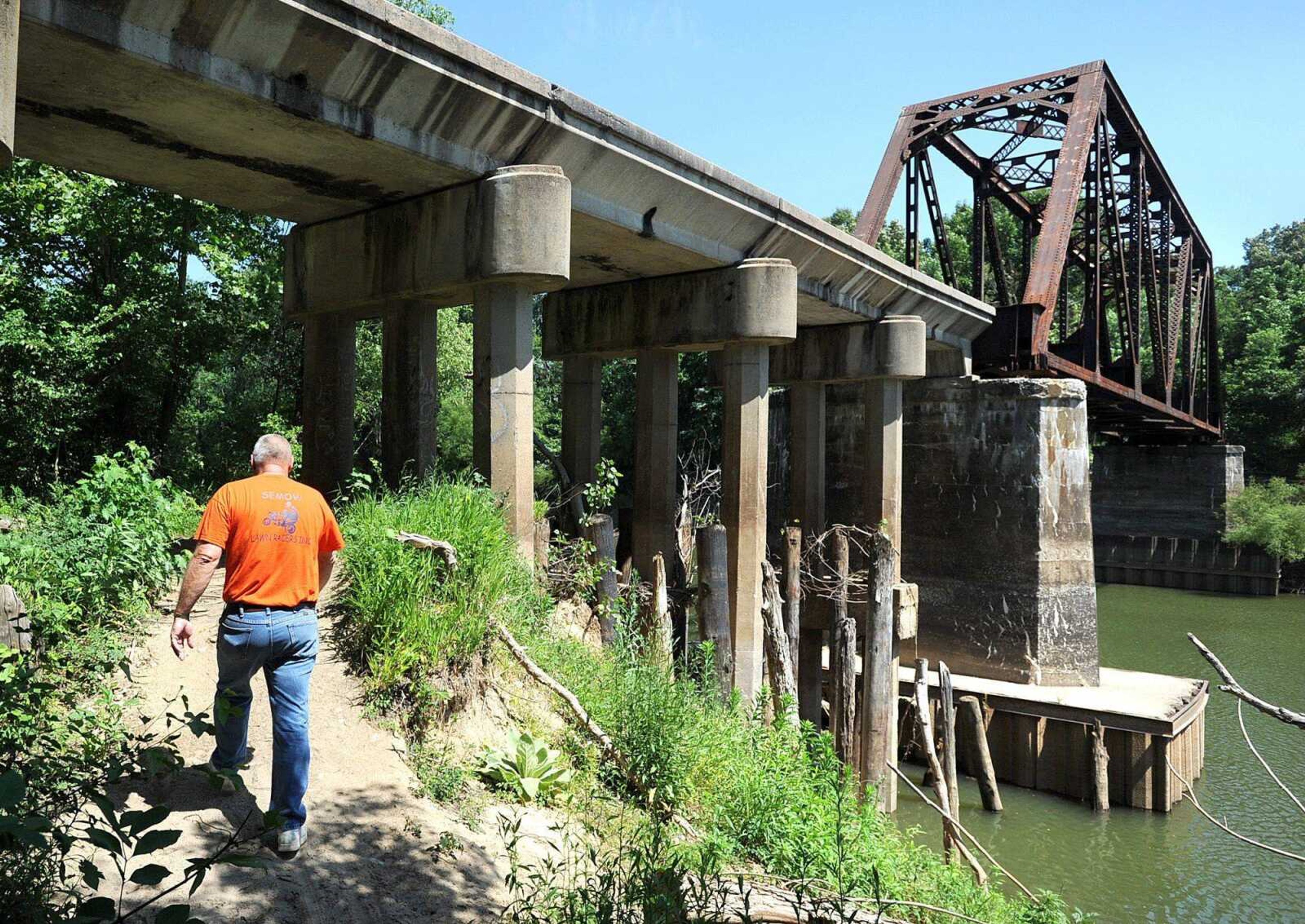 Phil Thompson walks under the railroad trestle that crosses the Diversion Channel Monday, May 21, 2012 near Allenville, Mo. Thompson, a life-long resident of Allenville, has used the trestle countless times throughout his life to get supplies during floods. (Laura Simon)