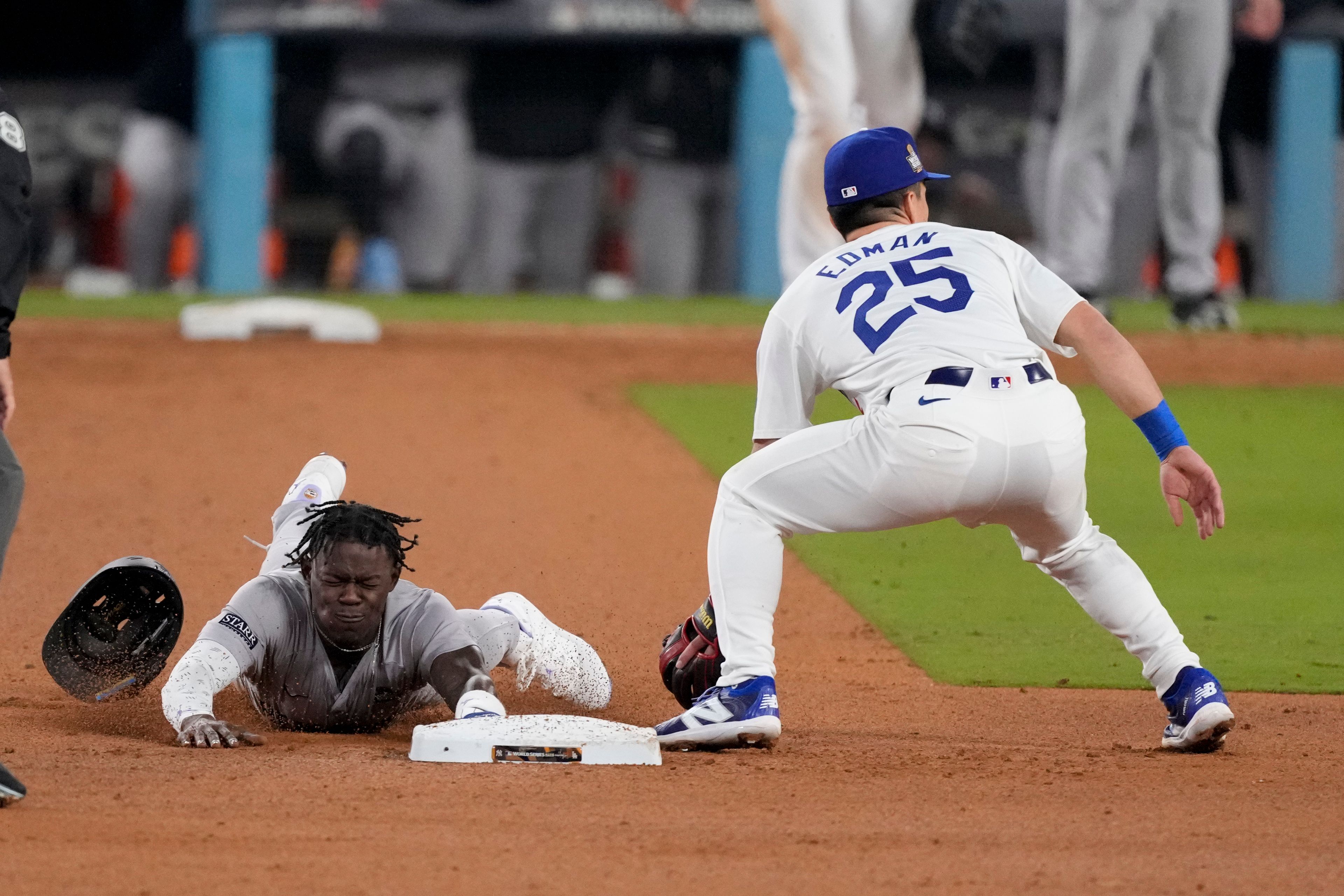 New York Yankees' Jazz Chisholm Jr. steals second base next to Los Angeles Dodgers shortstop Tommy Edman during the 10th inning in Game 1 of the baseball World Series, Friday, Oct. 25, 2024, in Los Angeles. (AP Photo/Mark J. Terrill)