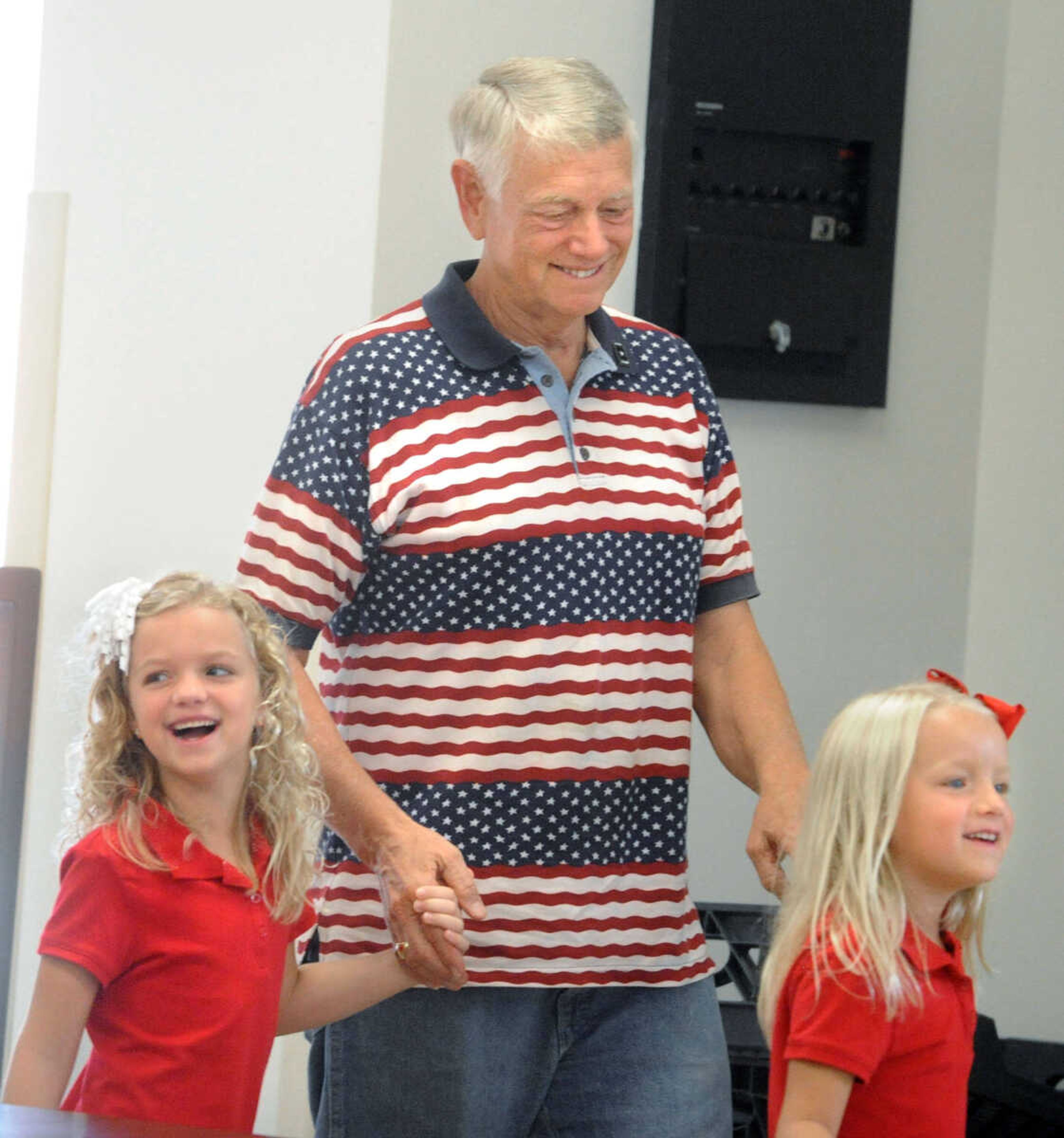 LAURA SIMON ~ lsimon@semissourian.com

Alma Schrader students Amiee, left, and Lindsey Caldwell escort Army veteran Jon Baker into the cafeteria to have their picture taken, Wednesday, Sept. 18, 2013, during 12th annual Constitution Day and Heroes Recognition Assembly at the elementary school. Students were invited to bring their heroes to introduce to the school during the celebration.