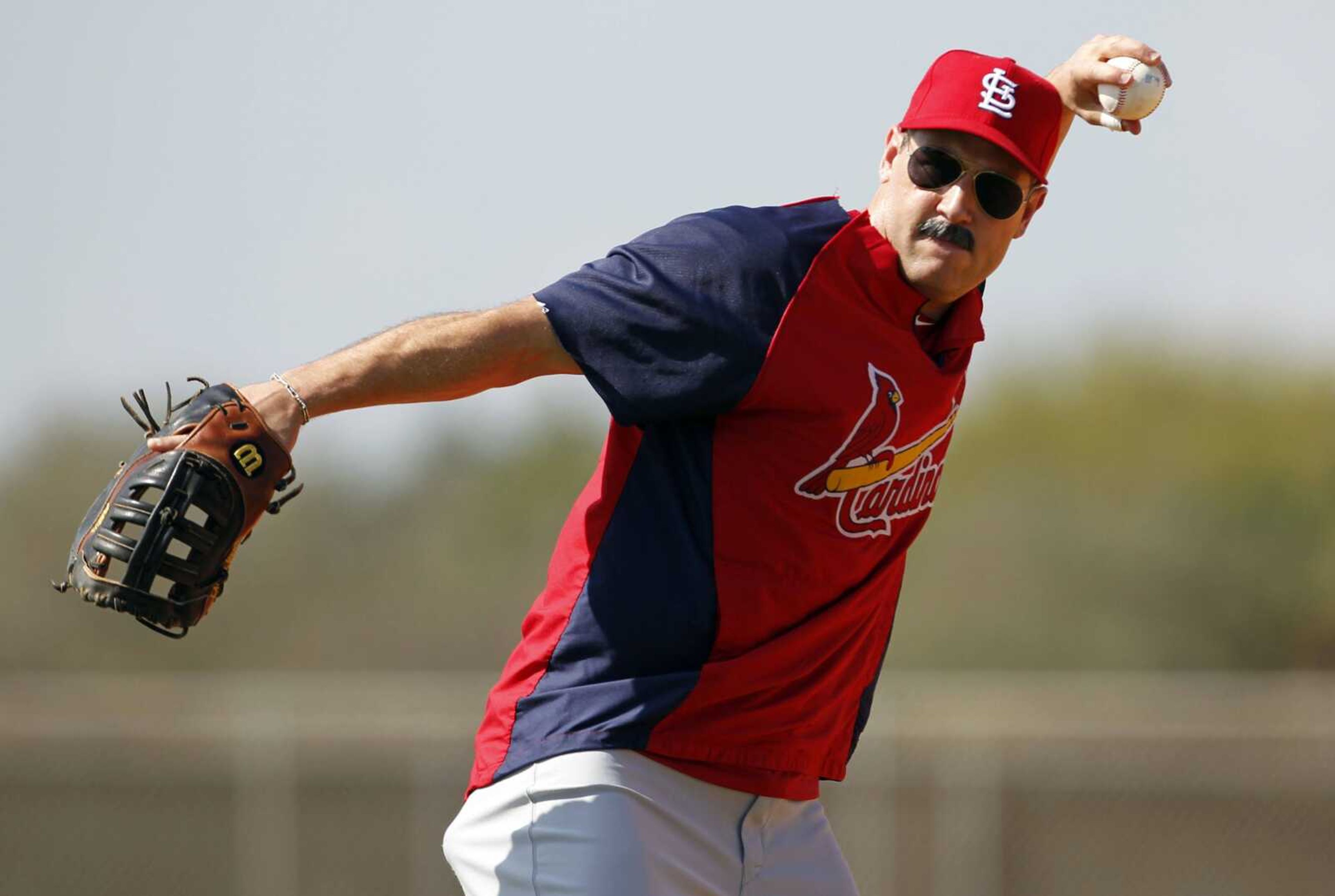 Cardinals first baseman Lance Berkman wears a fake mustache as he throws a ball during a spring training workout last month in Jupiter, Fla. (JEFF ROBERSON ~ Associated Press)