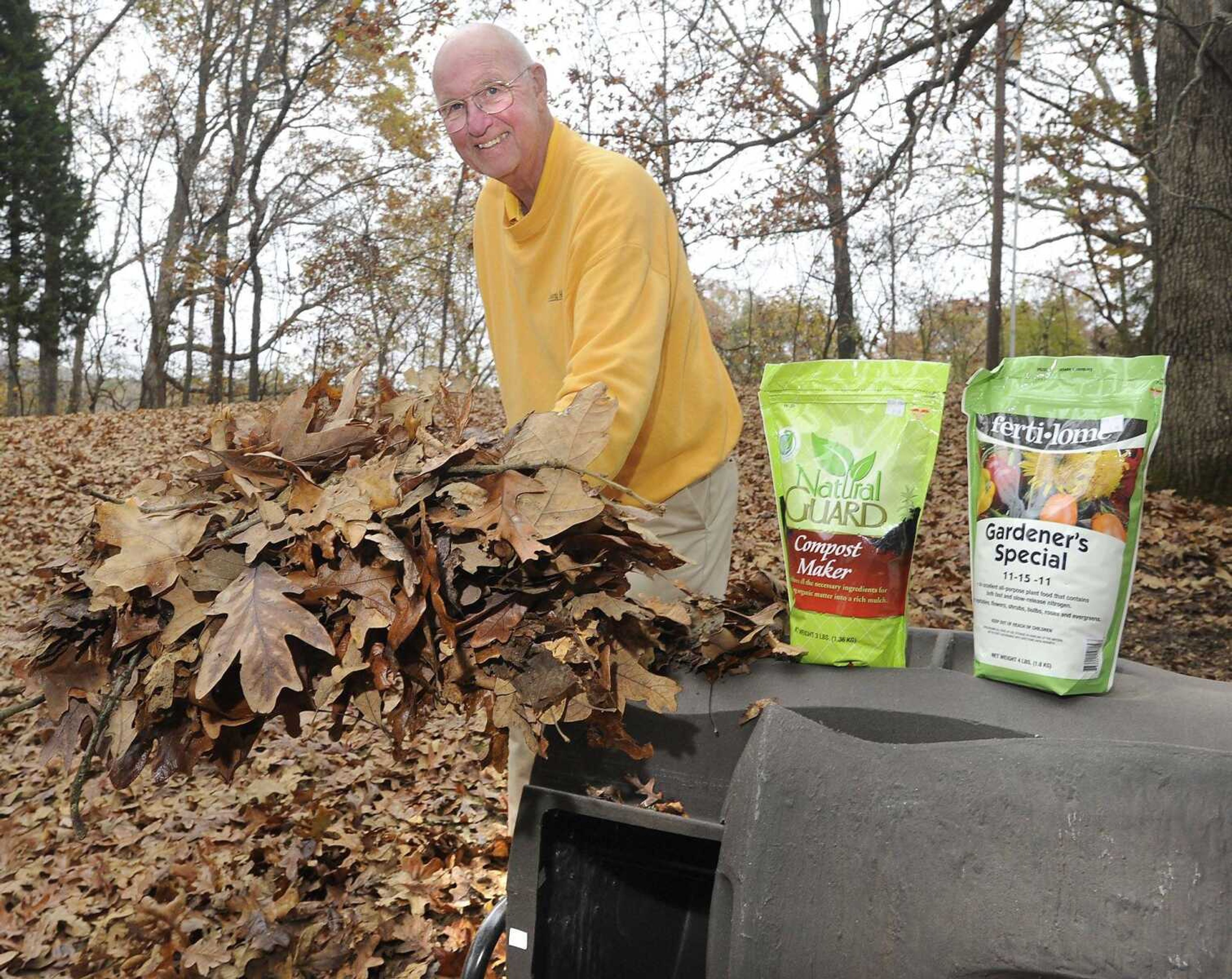 Paul Schnare shows a garden product, compost maker, which includes microorganisms that break down organic matter into compost, and fertilizer with a tumbling composter. (Fred Lynch)