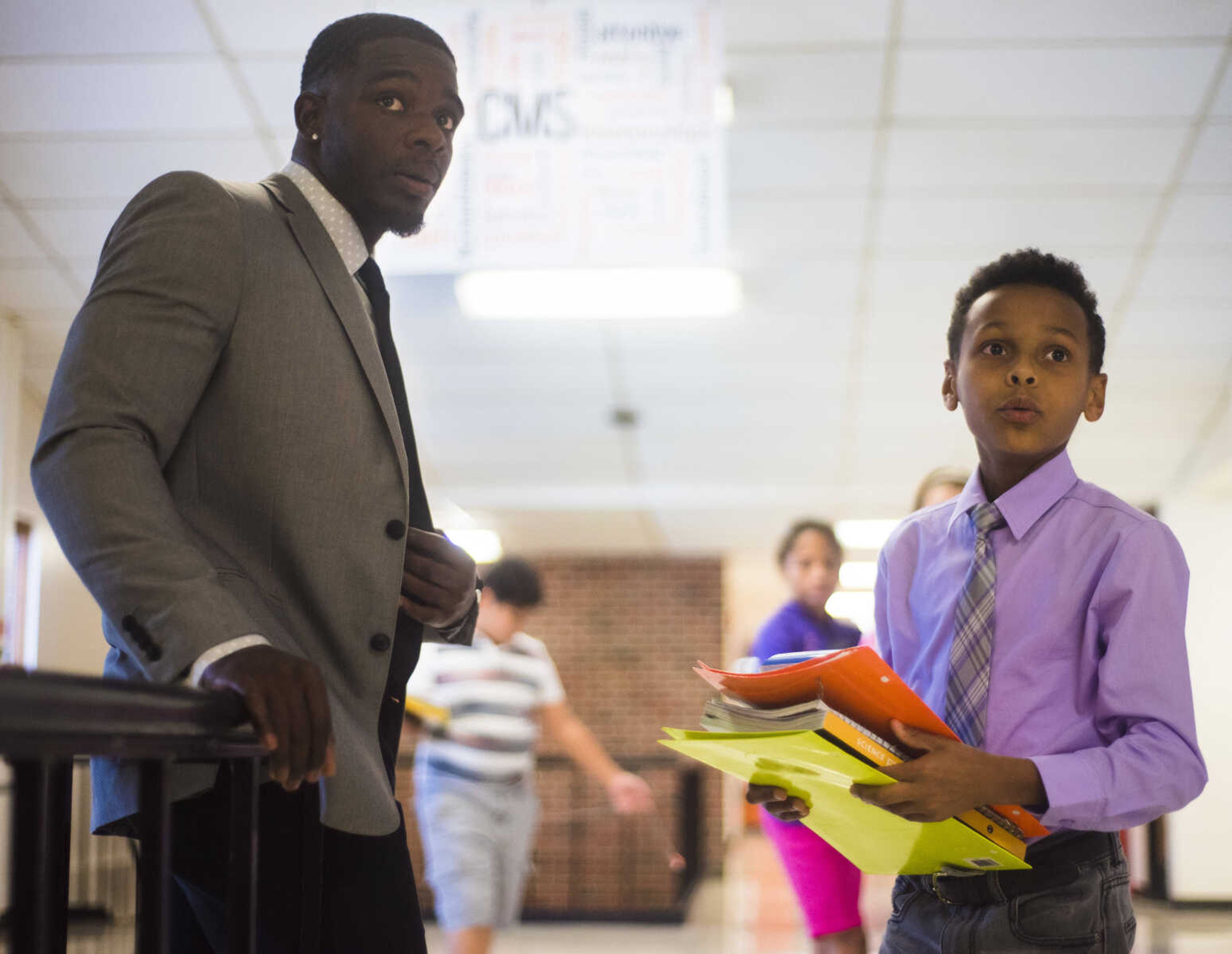 Honorable Young Mens Club leader Cantrell Andrews talks to Riley Davis, 10, Sept. 19, 2017 at Central Middle School in Cape Girardeau.