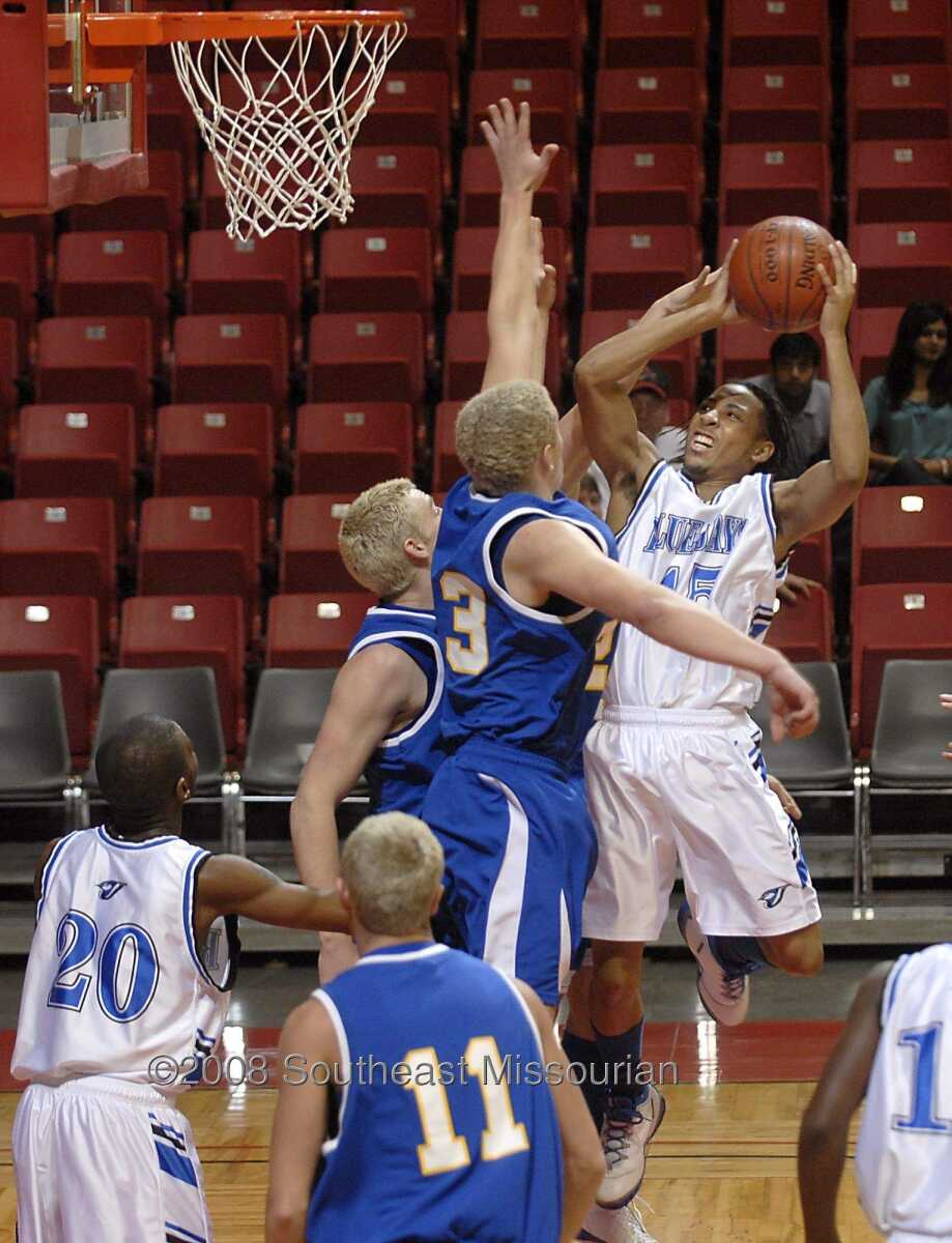 KIT DOYLE ~ kdoyle@semissourian.com
Charleston's Donald Dixon, right, gets off a shot past Scott City defenders Friday, December 26, 2008, in the first round of the Southeast Missourian Christmas Tournament at the Show Me Center.