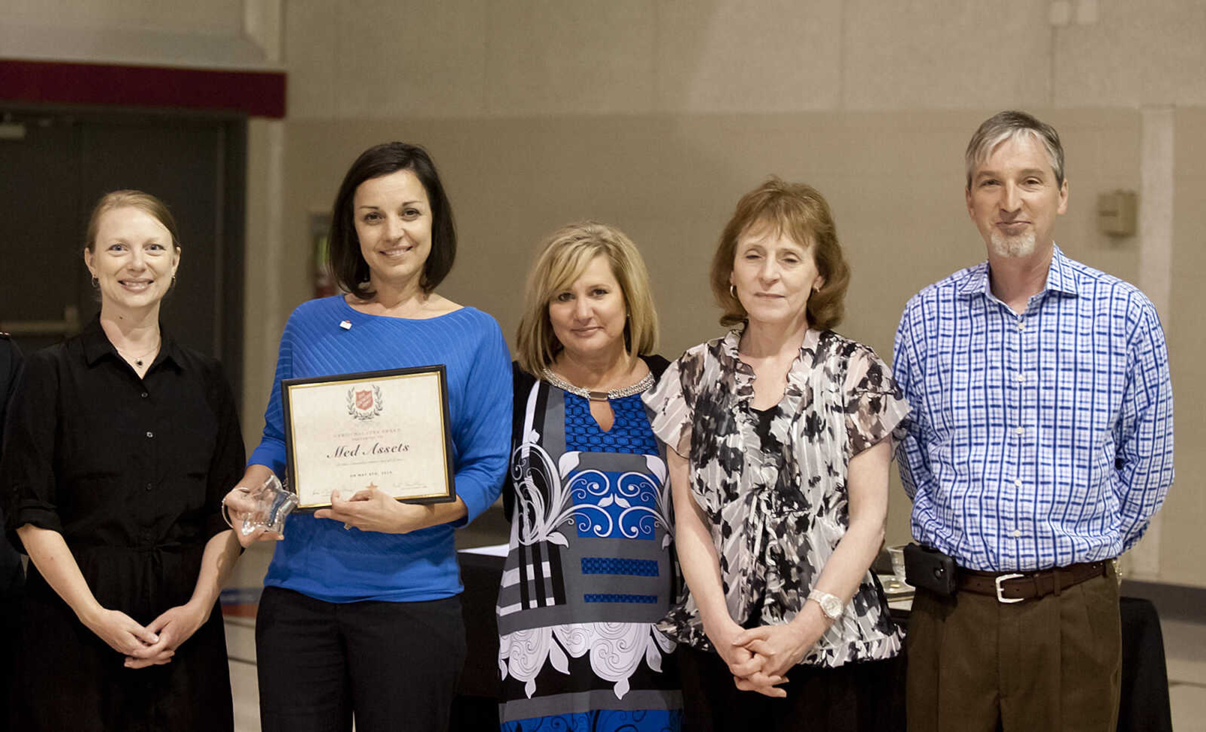 Representatives of Med Assets pose after receiving the Christmas Star Award during the Cape Girardeau Salvation Army's annual dinner, "A Night with the Stars," Thursday, May 8, at the Cape Girardeau Salvation Army.