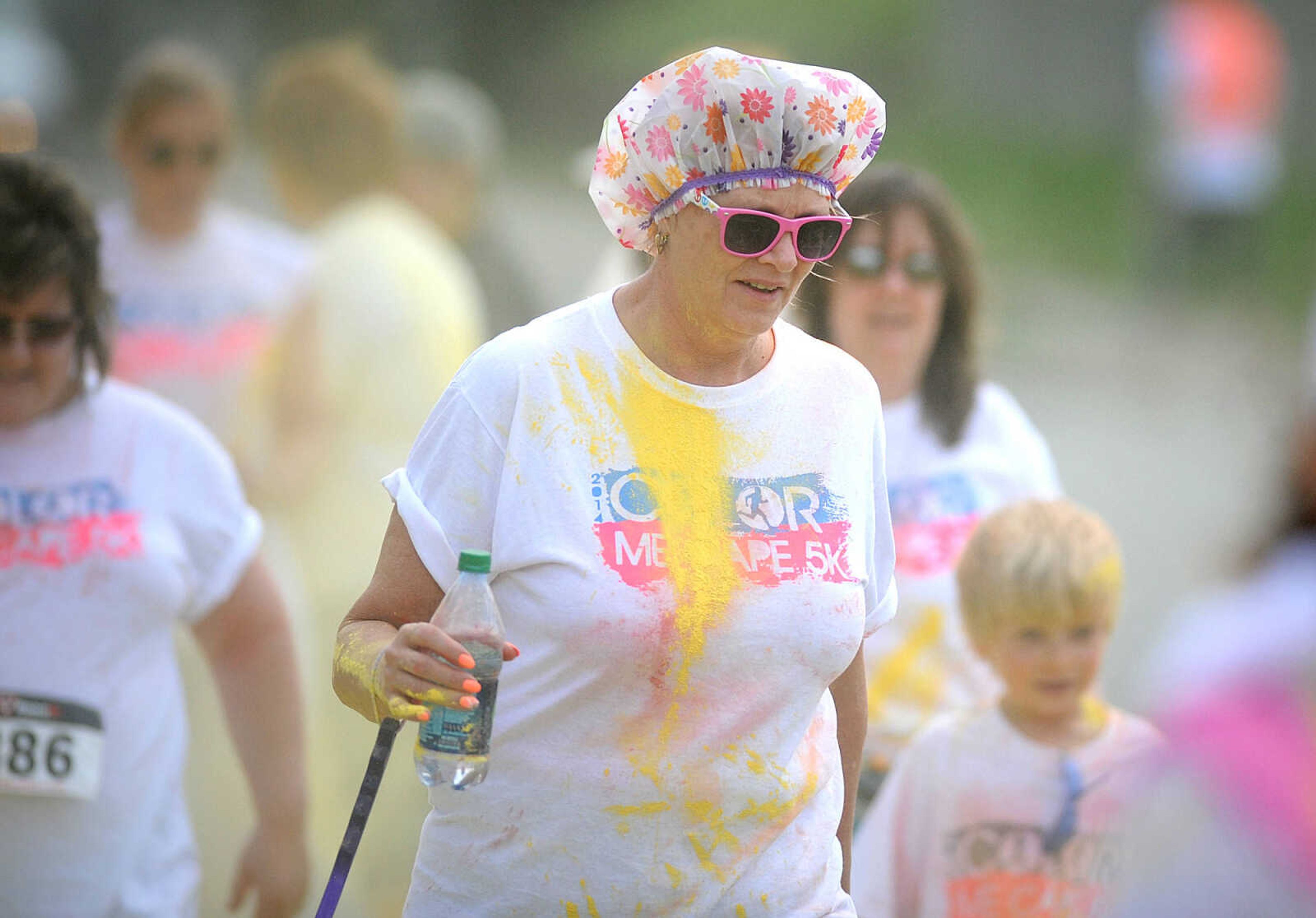 LAURA SIMON ~ lsimon@semissourian.com

Participants in the Color Me Cape 5K are sprayed with yellow powder at the second color station on Frederick Street, Saturday, April 12, 2014, in Cape Girardeau.