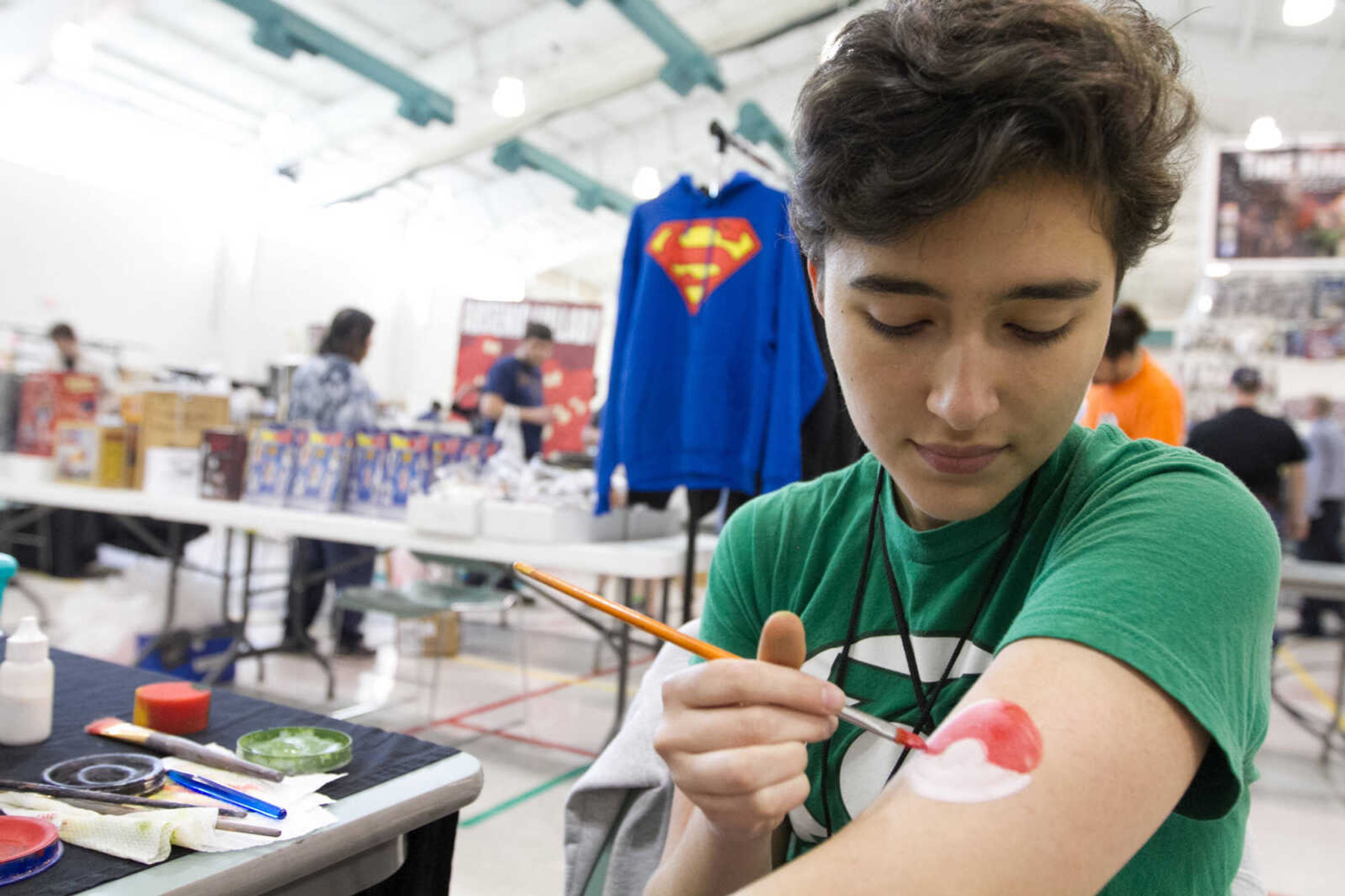 GLENN LANDBERG ~ glandberg@semissourian.com


Tessa Valleroy paints a pokeball on her arm between customers at a face painting booth during Cape Comic Con Friday, April 17, 2015 at the Osage Centre.