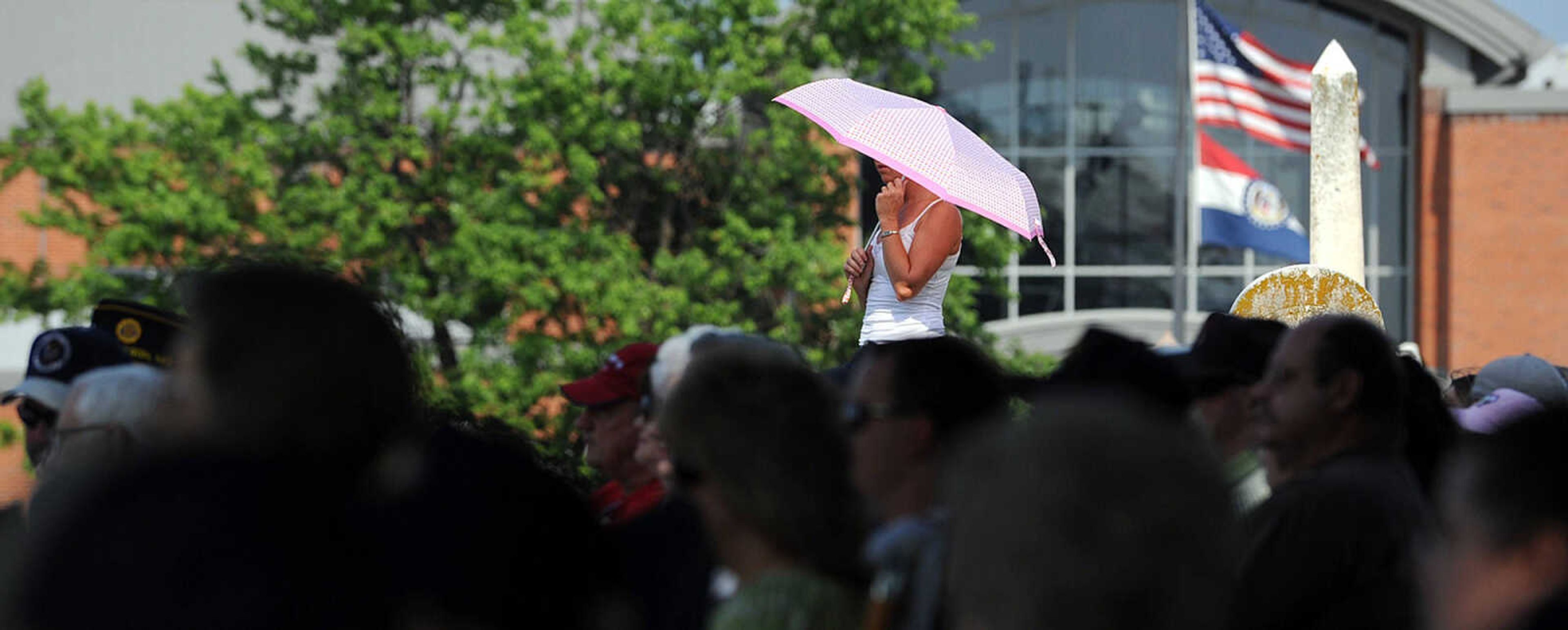 LAURA SIMON ~ lsimon@semissourian.com
A woman shields herself from the morning sun Monday morning, May 28, 2012 during the Memorial Day service at Jackson City Cemetery.