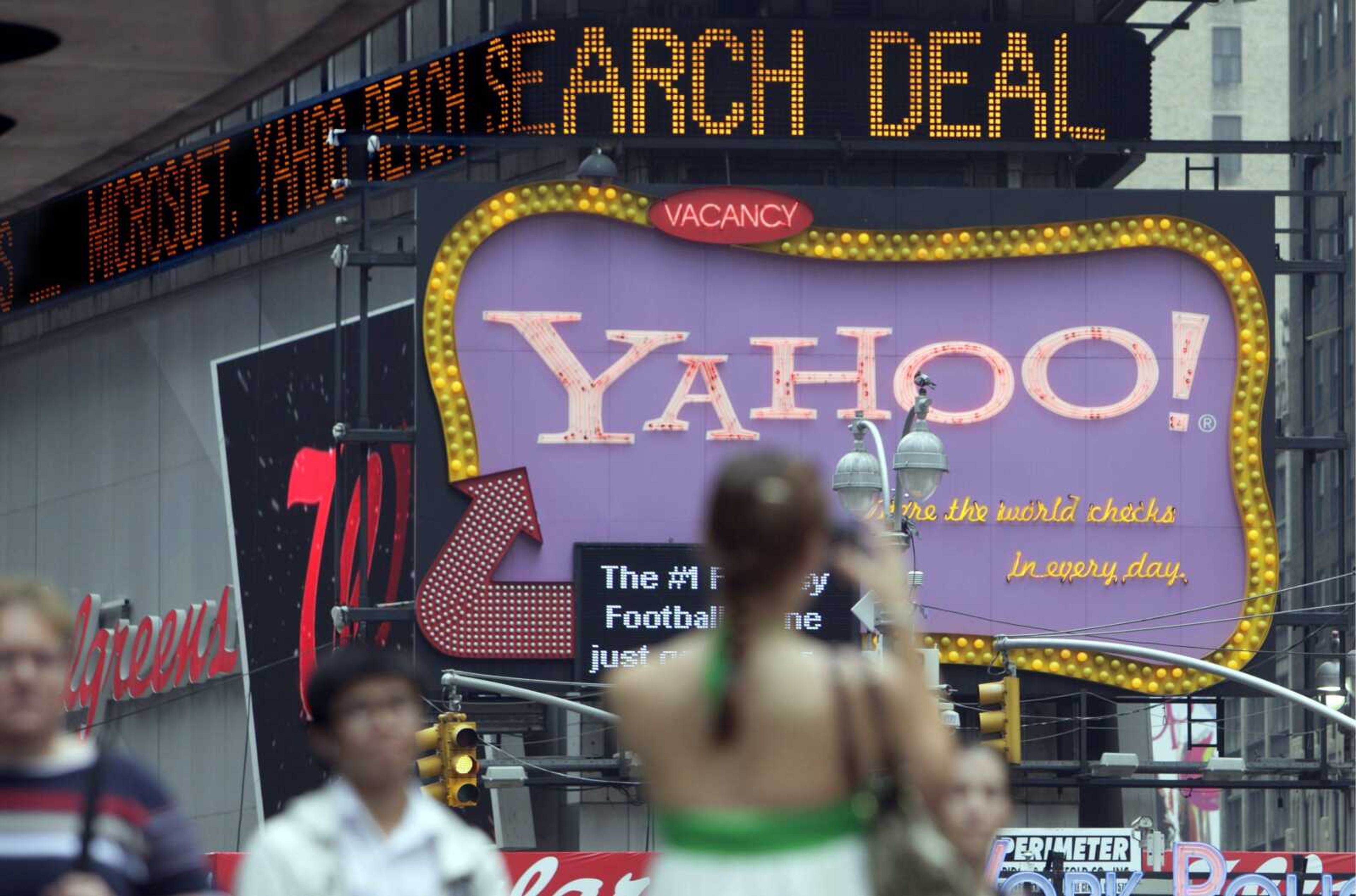 The news headline "zipper" in New York's Times Square announces a Microsoft deal with Yahoo on Wednesday. (Richard Drew ~ Associated Press)