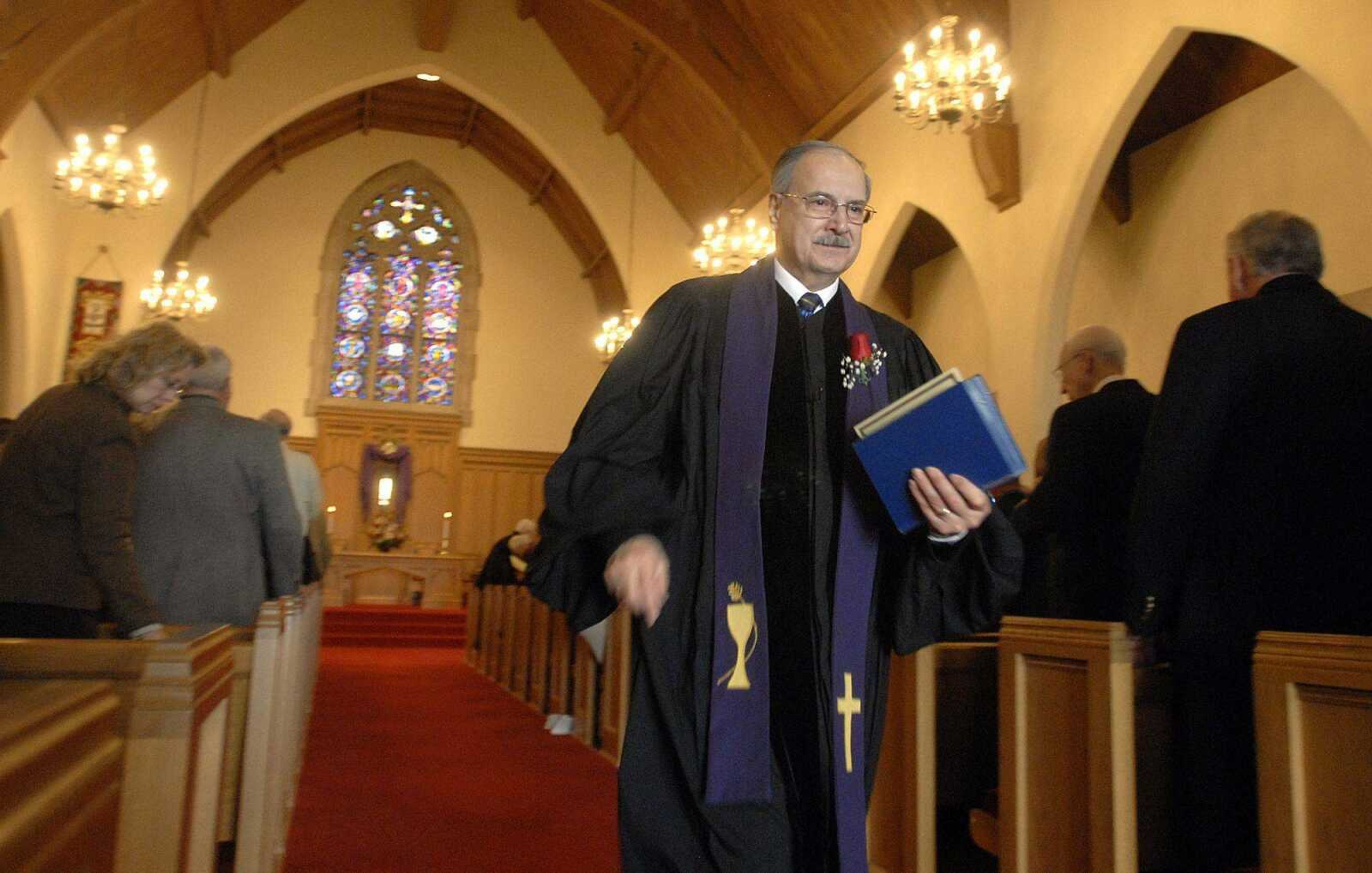 Rev. Paul Kabo, Jr. walks past his parishioners after giving his last sermon at First Presbyterian Church Sunday, February 28, 2010. Kabo is retiring after ten years of service to the church. (LAURA SIMON)