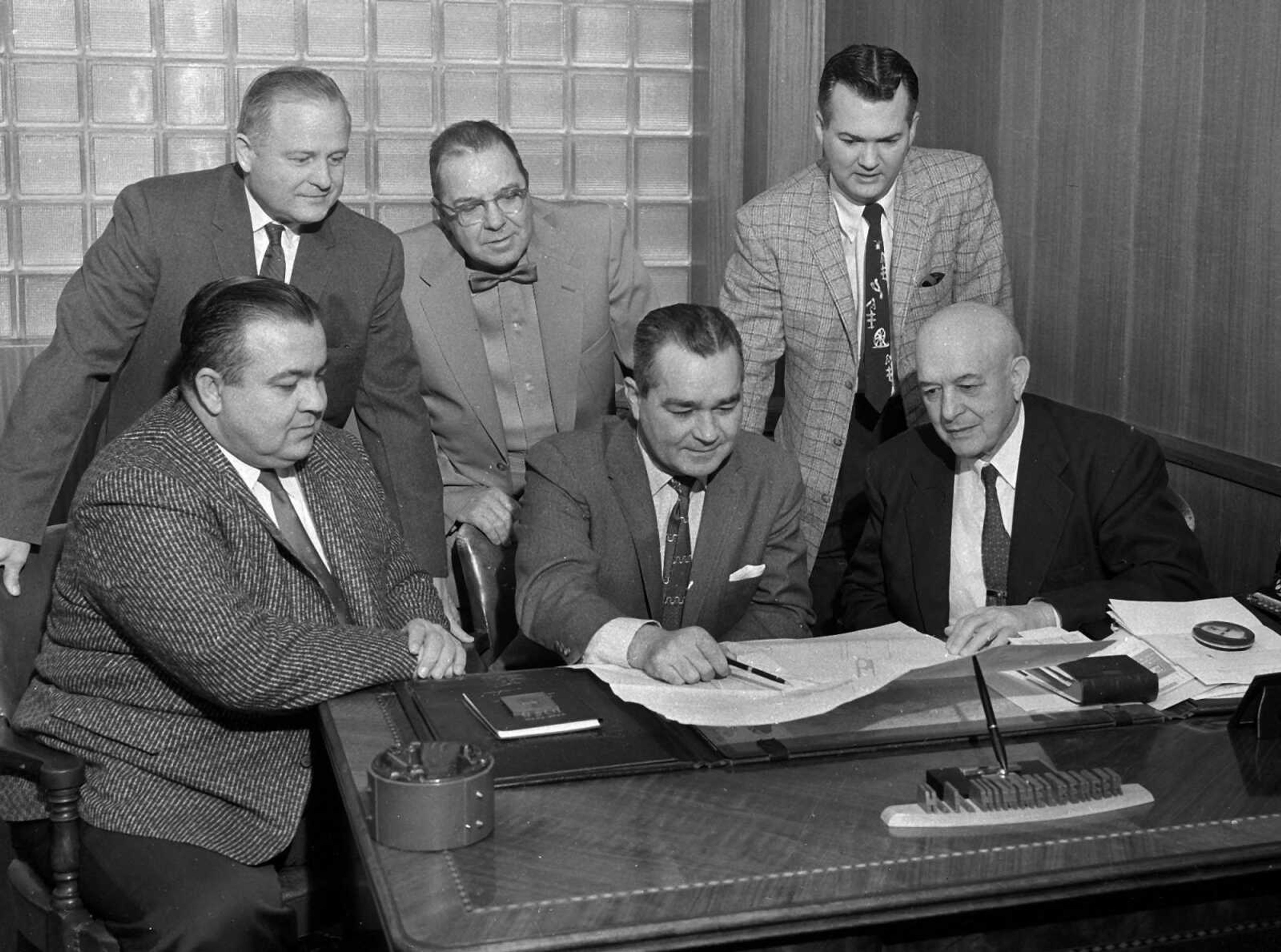 Southeast Missourian archive
A drawing of the proposed layout for Municipal Airport under the pending construction program is viewed here by the Municipal Airport Board. Seated, from left, are: Rush Limbaugh Jr., secretary; Maurice T. Dunklin, chairman; H.I. Himmelberger. Standing, from left, Mayor Walter H. Ford, ex officio member; Dr. Paul B. Nussbaum and Robert J. Earley. Present plans call for bids to be received in May and for construction of runways, taxi-strips and terminal building to begin about July 1. The city's bonds, $295,000 voted last summer, will not be sold until plans and bids are approved by the Civil Aeronautics Authority, which will match the local cost up to the amount of the bonds. (Southeast Missourian, Feb. 1, 1958)