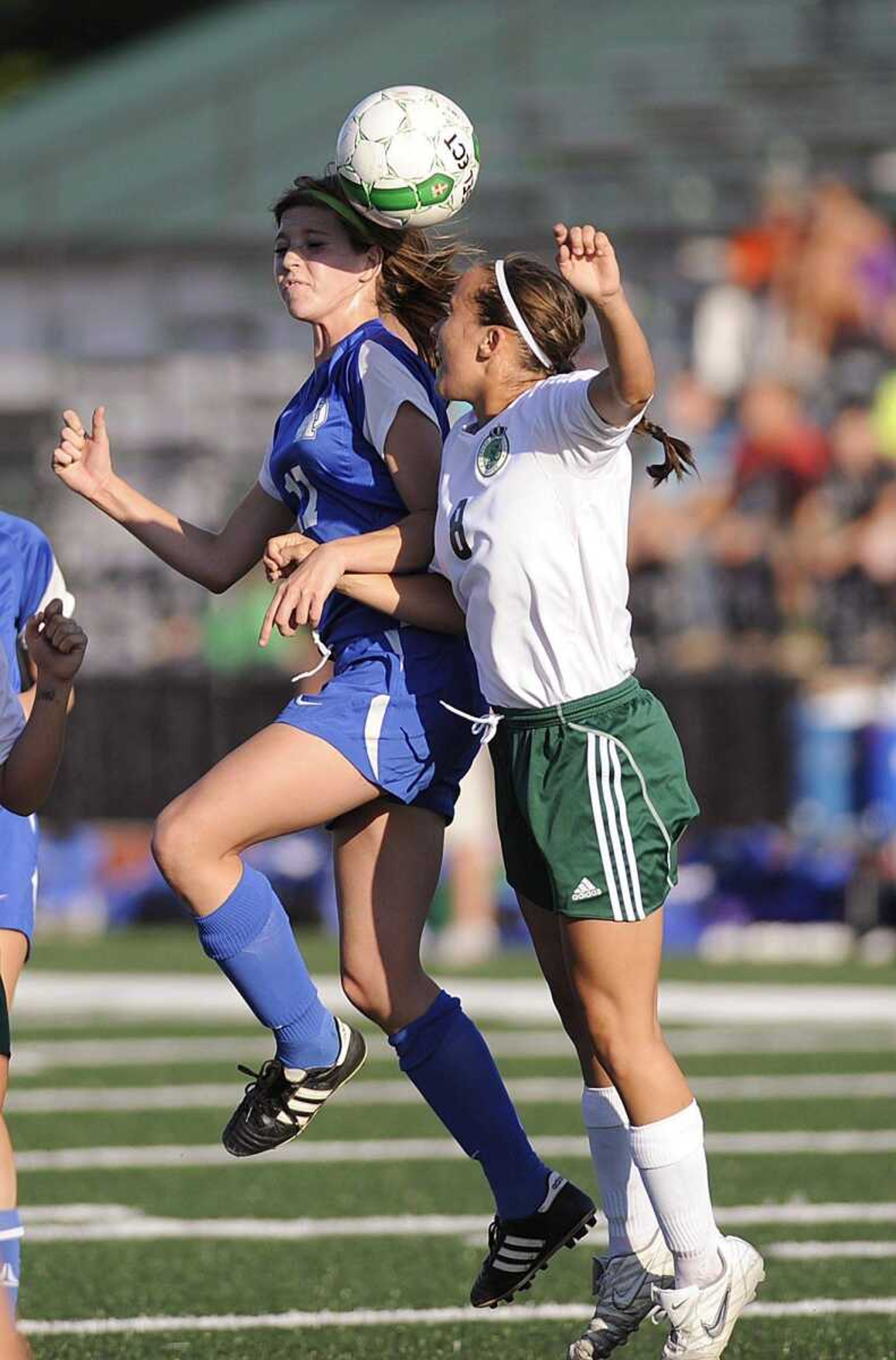 Notre Dame midfielder Abby Boyer challenges De Soto defender Courtney Krodinger for a header during the Bulldogs&#8217; 2-1 overtime win in a Class 2 sectional game Tuesday in De Soto, Mo. (ADAM VOGLER)