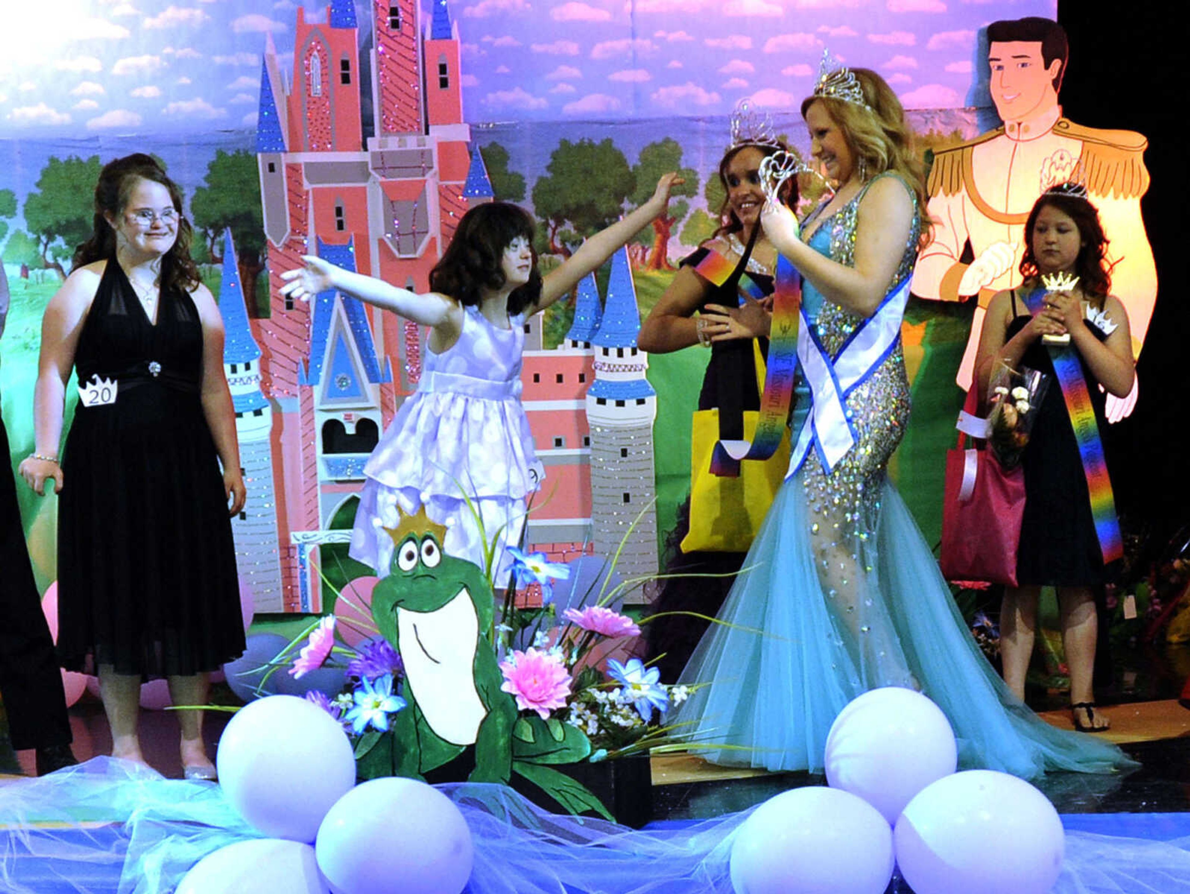 Emma Watson receives her crown from Courtney Todt in the 10-14 age division of the S. E. Missouri Angels Pageant on Saturday, April 26, 2014 at Scott City High School.