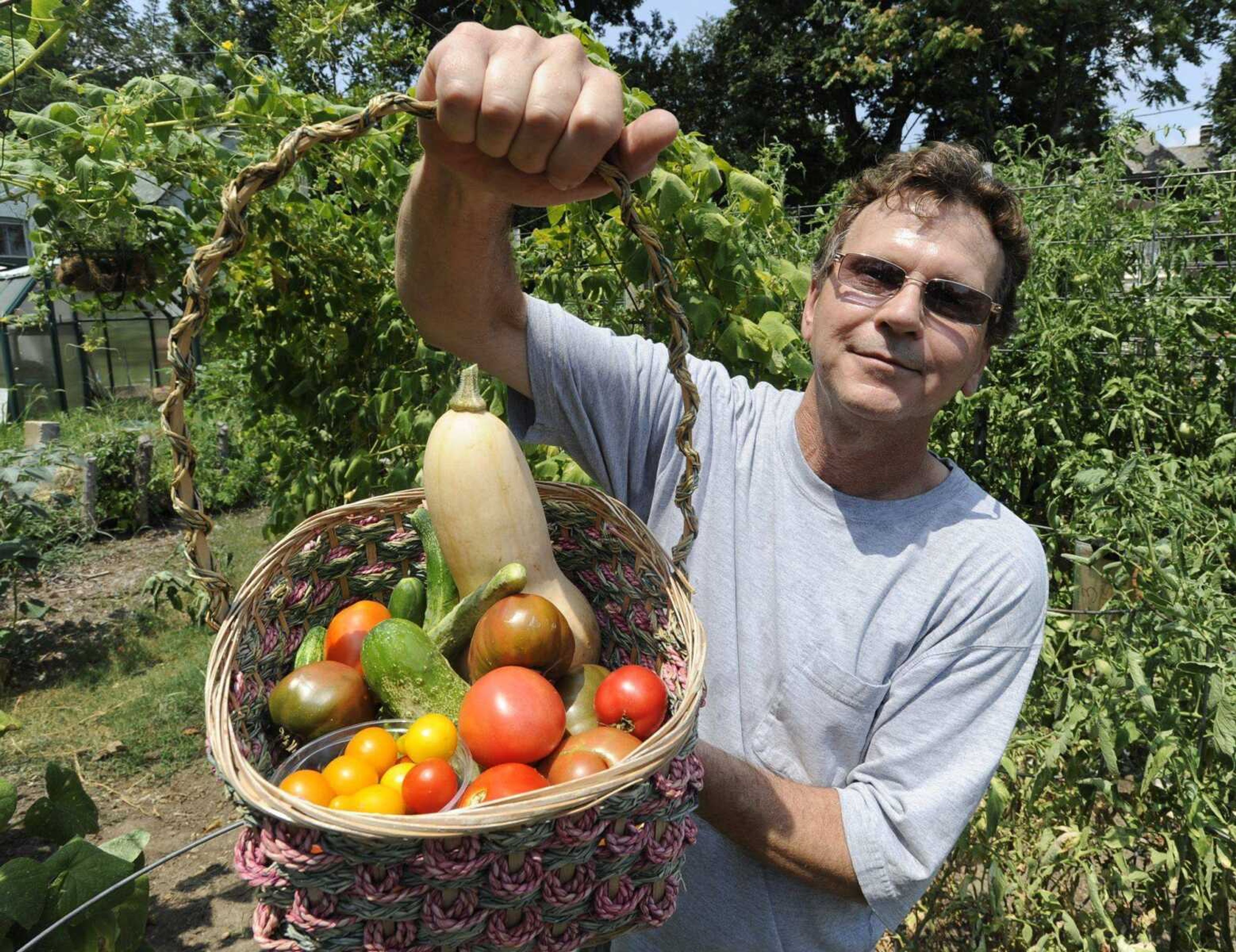 Bill Dunn shows some of the produce Saturday from the Scholarship Garden in Cape Girardeau. (Fred Lynch)