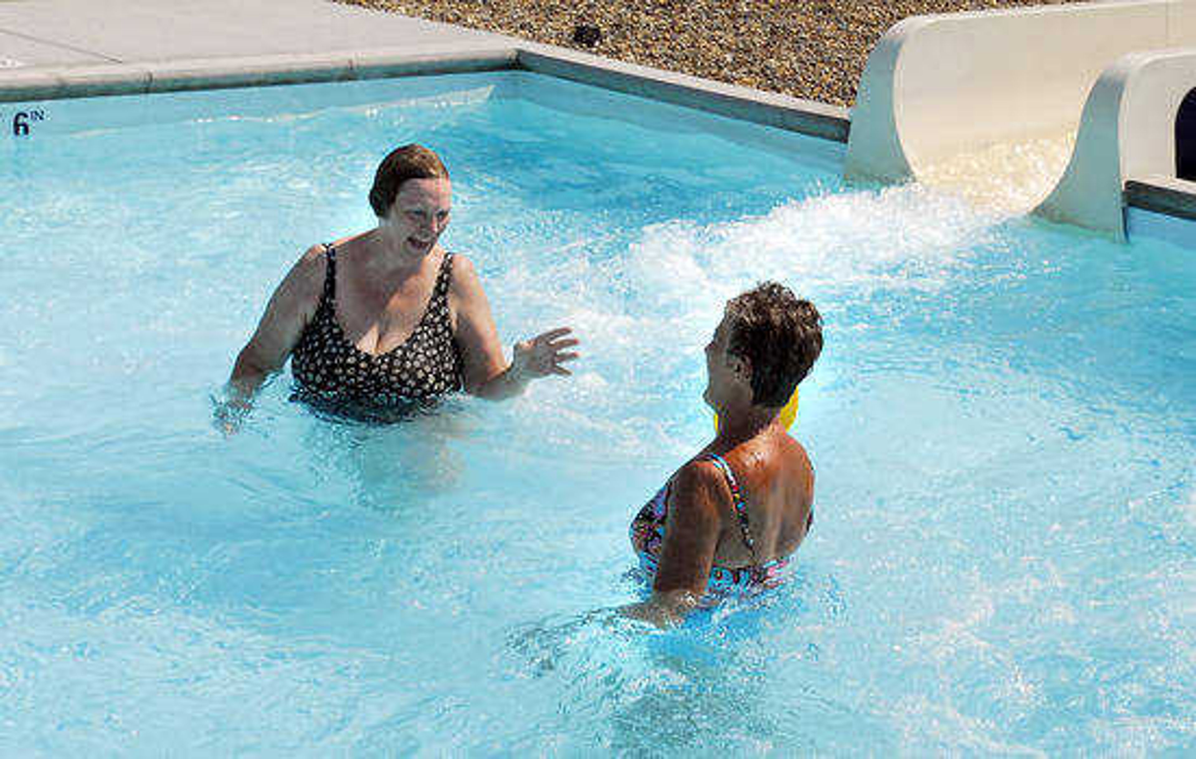 Joyce Sinclair and Brenda Hasty share a laugh after racing each other down the water slides at Cape Splash Family Aquatic Center in Cape Girardeau. (lsimon@semissourian.com)