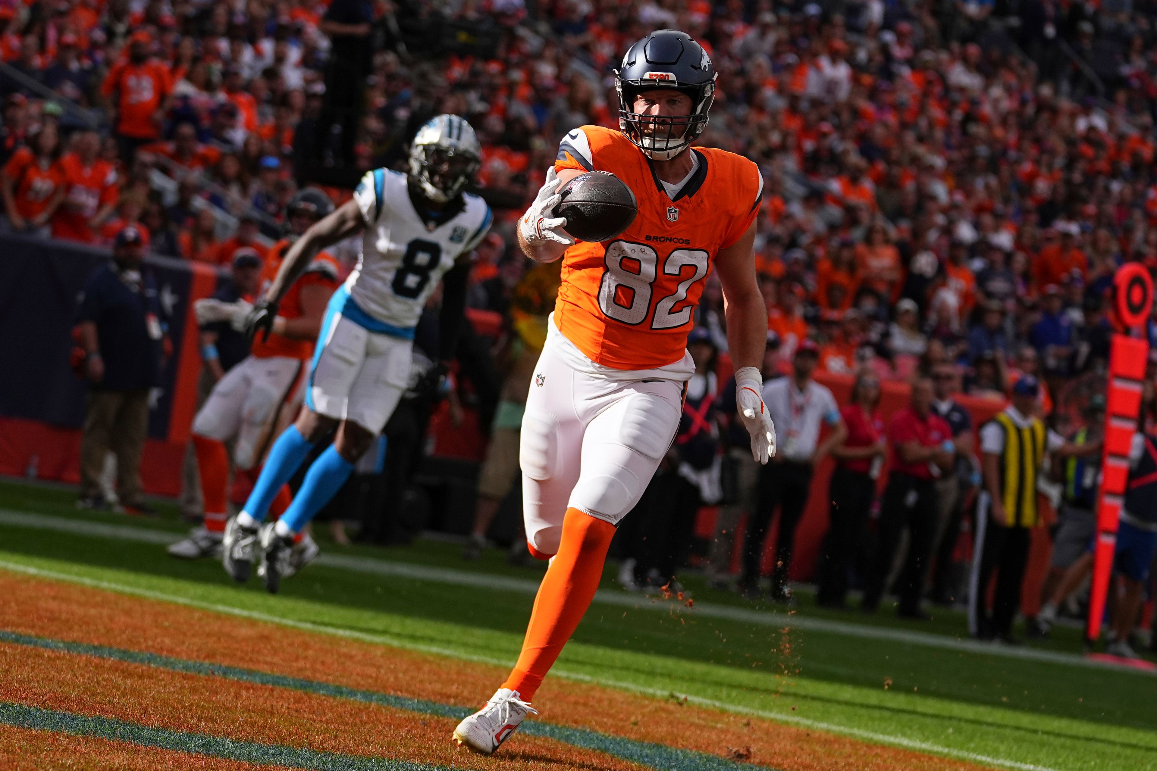 Denver Broncos tight end Adam Trautman (82) catches a pass for a touchdown against the Carolina Panthers during the first half during an NFL football game Sunday, Oct. 27, 2024, in Denver. (AP Photo/Bart Young)