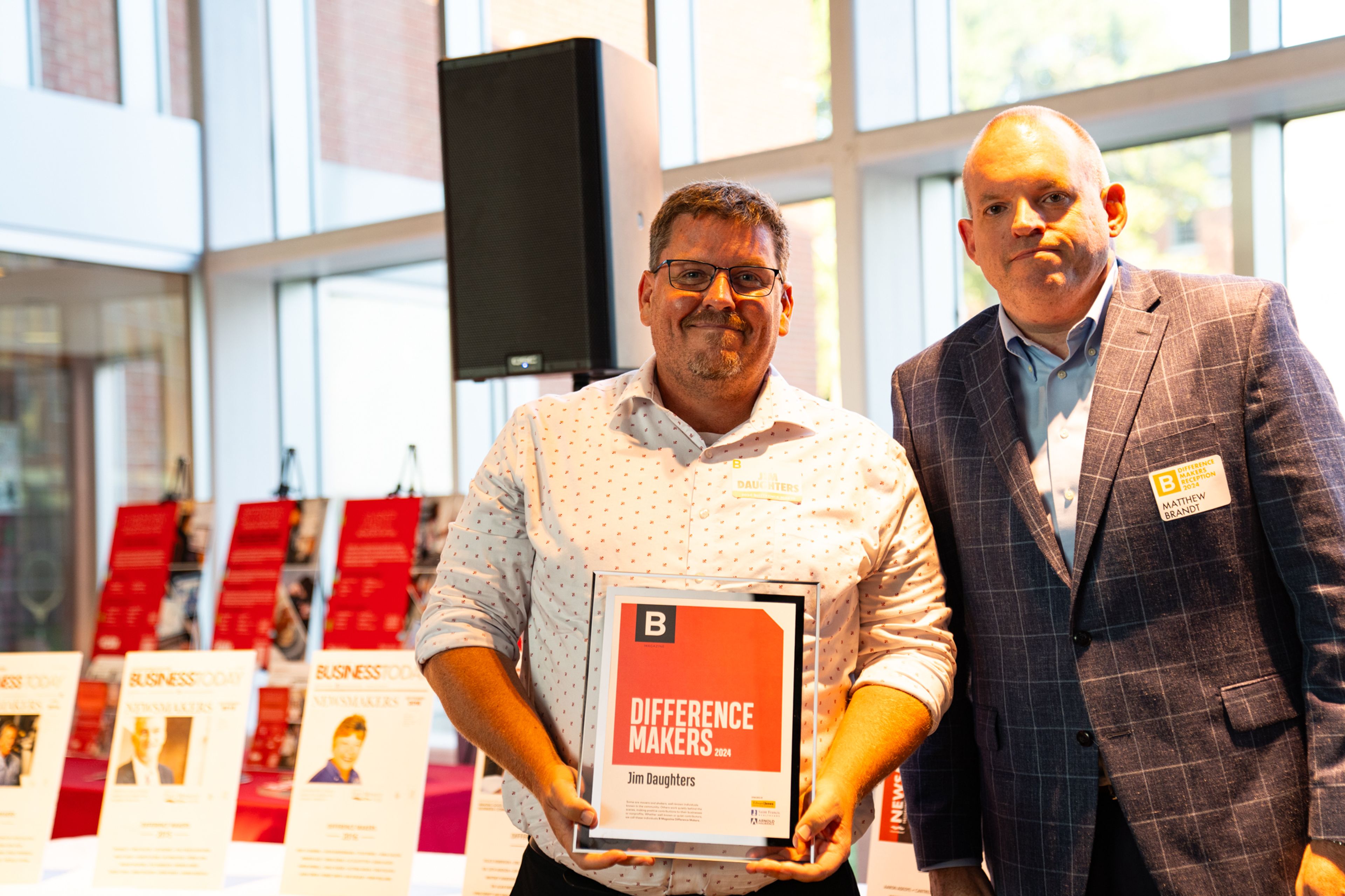 Jim Daughters receives a plaque from Saint Francis Healthcare System’s Matthew Brandt recognizing him as a 2024 Difference Maker at their reception at Southeast Missouri State University’s River Campus. The Difference Maker’s reception was presented by B Magazine on Thursday, Sept. 6.