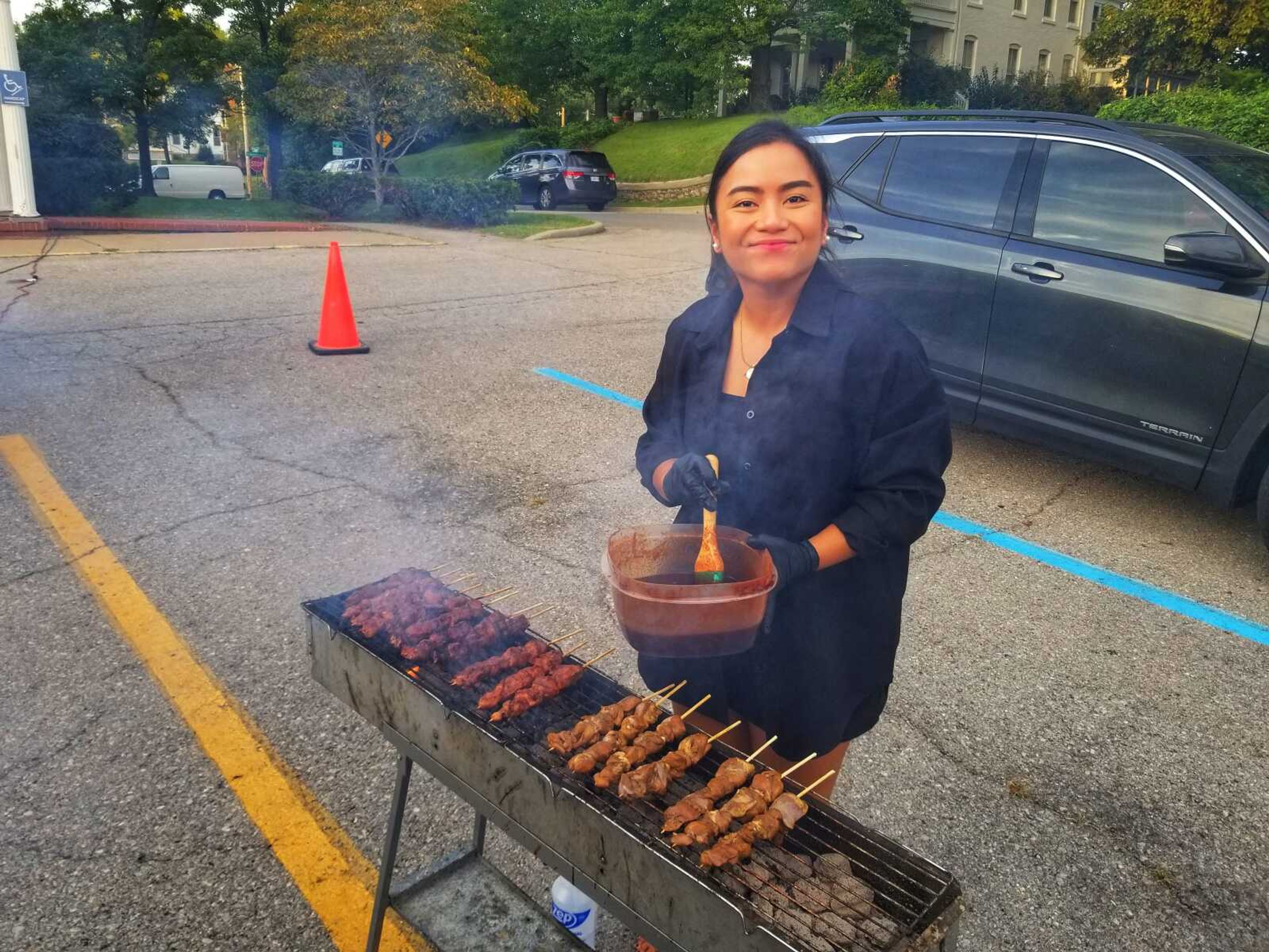 Mia Antallan of Cora's Taste of Manila prepares skewers Sept. 13 in the parking lot of the former Cape Girardeau City Hall, now owned by Kellerman Foundation for Historic Preservation. Antallan relocated to the U.S. in March 2020.