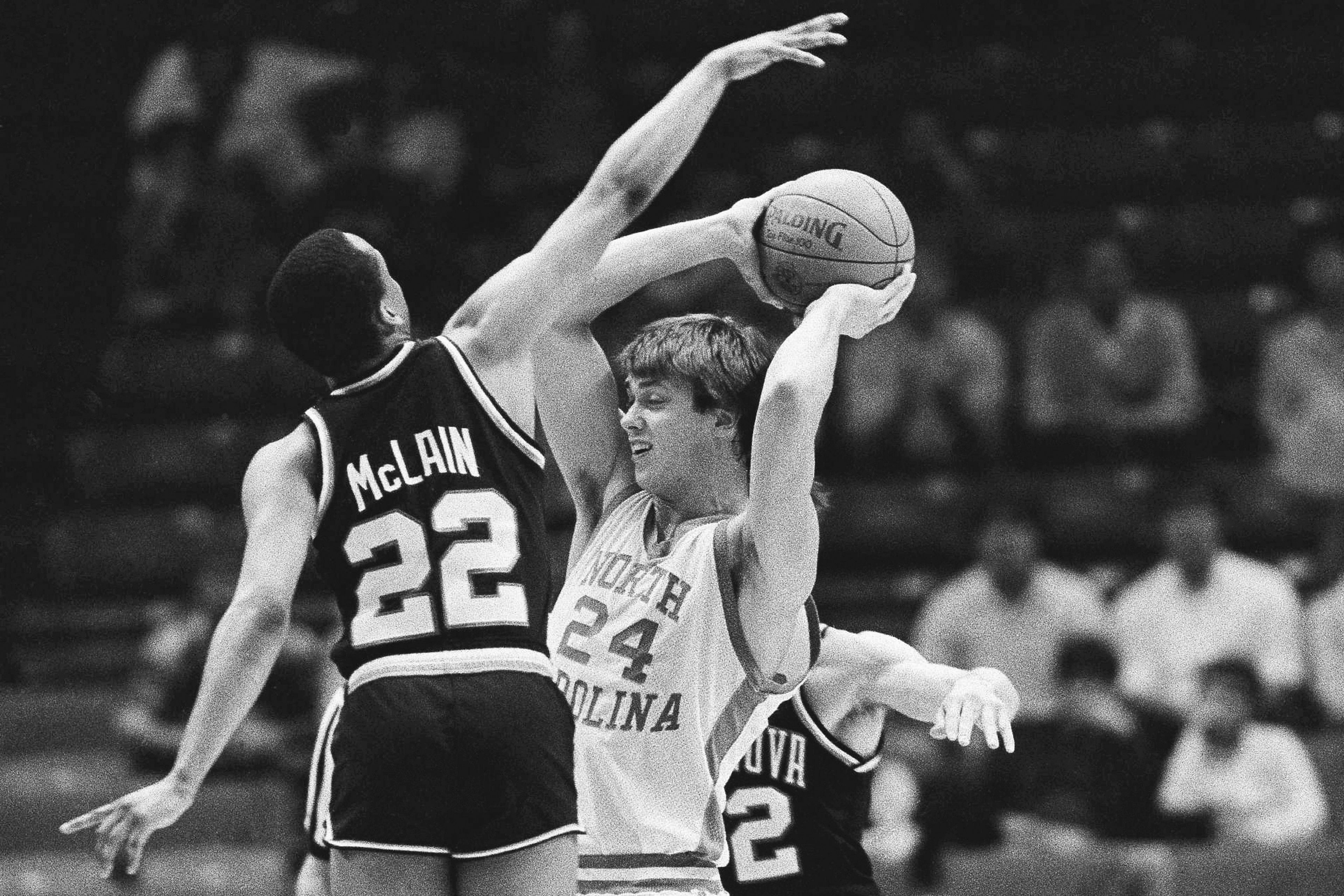 North Carolina's Joe Wolf (24) is stopped by Villanova players Gary McLain (22) and Harold Jensen (32) during early action at NCAA Southeast Regional finals at Birmingham, Ala., March 24, 1985. (AP Photo/File)