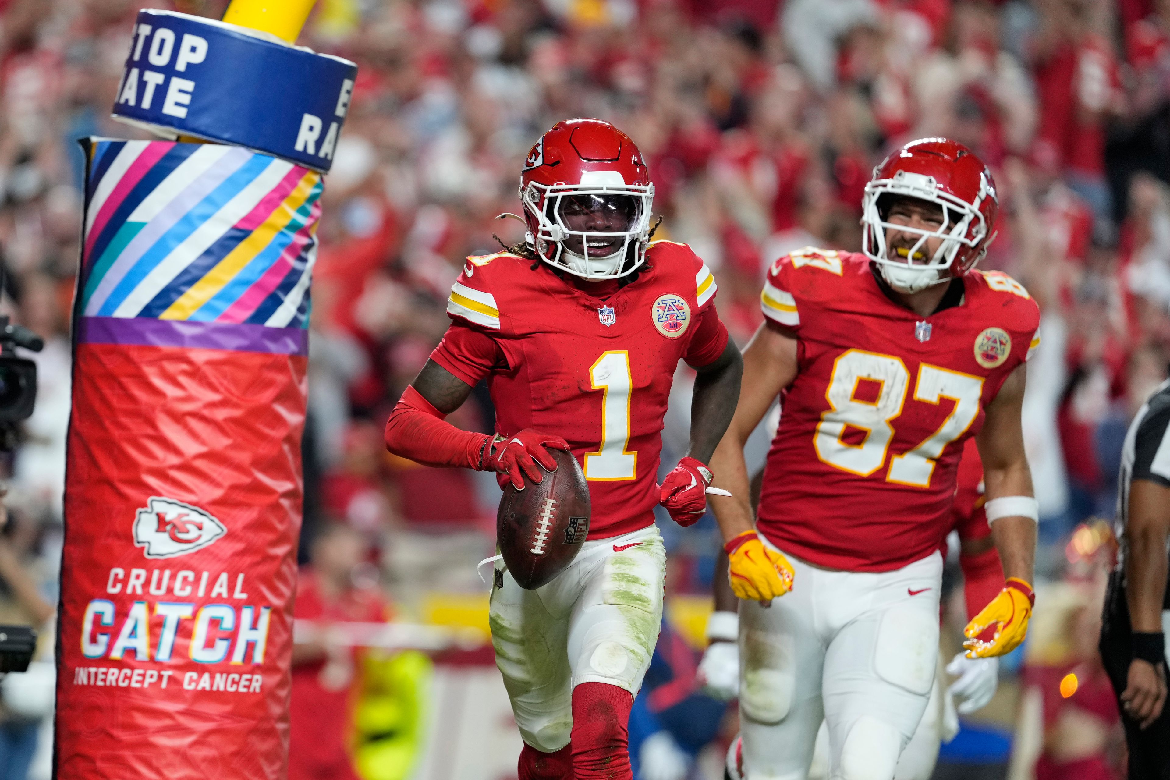 Kansas City Chiefs wide receiver Xavier Worthy (1) celebrates after scoring as teammate Travis Kelce (87) watches during the second half of an NFL football game against the New Orleans Saints Monday, Oct. 7, 2024, in Kansas City, Mo. (AP Photo/Ed Zurga)