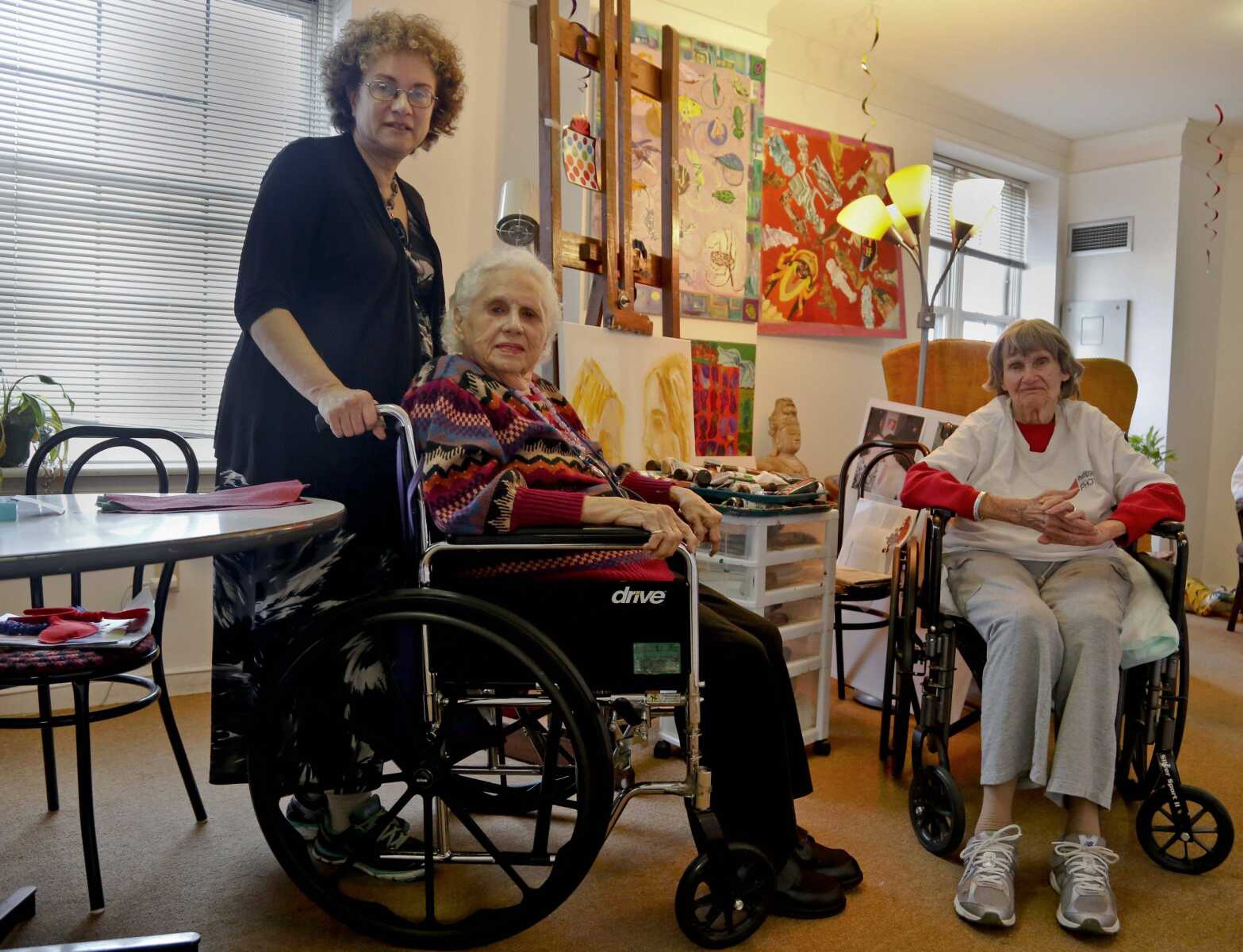 Alice Singer, center, an artist who is a resident of the assisted living apartments Prospect Park Residence, is visited by her daughter Joyce Singer, left, and her next-door neighbor, Annemarie Mogil, in the Brooklyn borough of New York on Thursday.