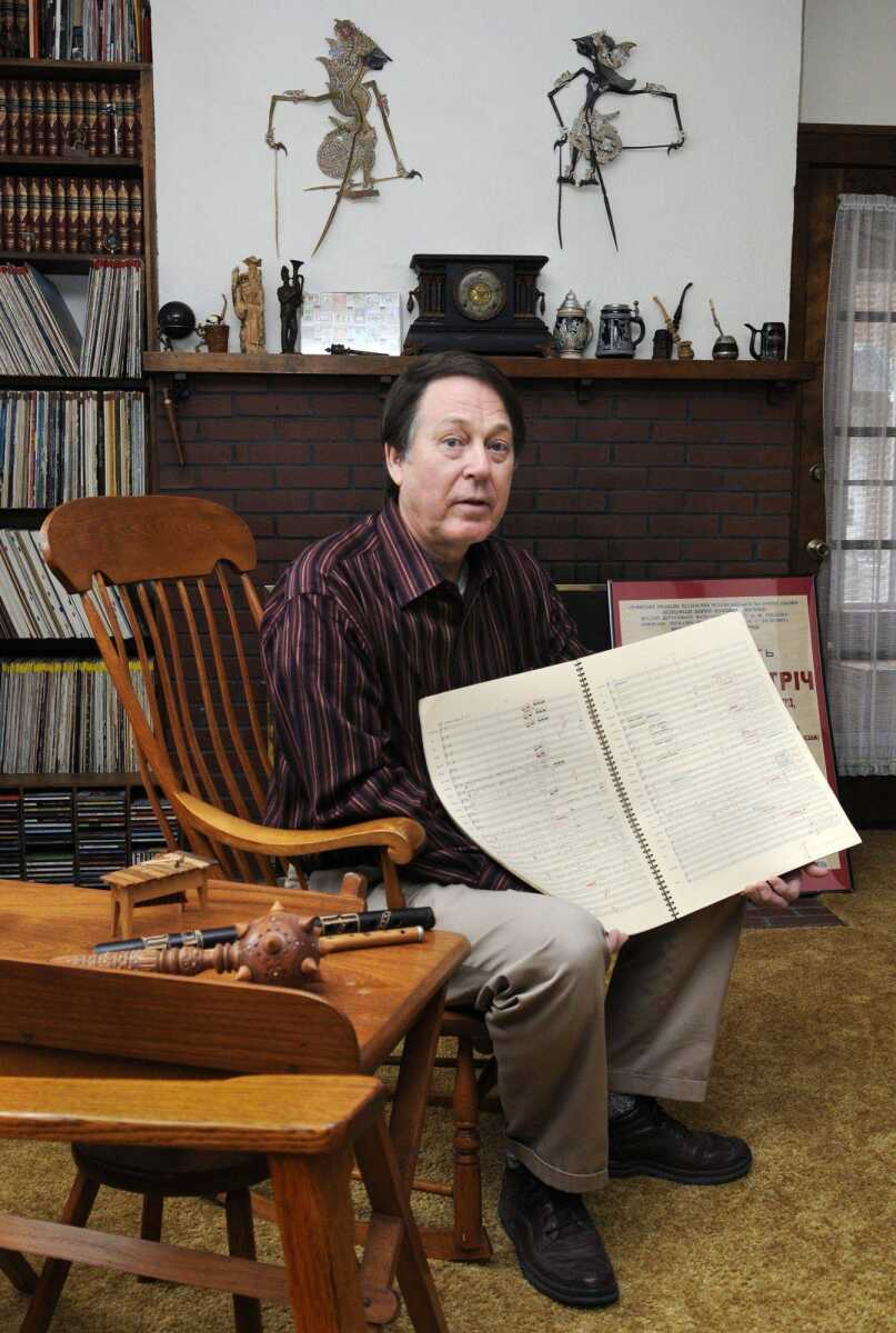 Retired Southeast Missouri State University music professor Dr. Robert Gifford poses in his home with some of the music, instruments, and keepsakes he has acquired throughout a music career that has taken him to the Ukraine and many other countries. Gifford recently won the Missouri Arts Award for Arts in Education. (KRISTIN EBERTS)