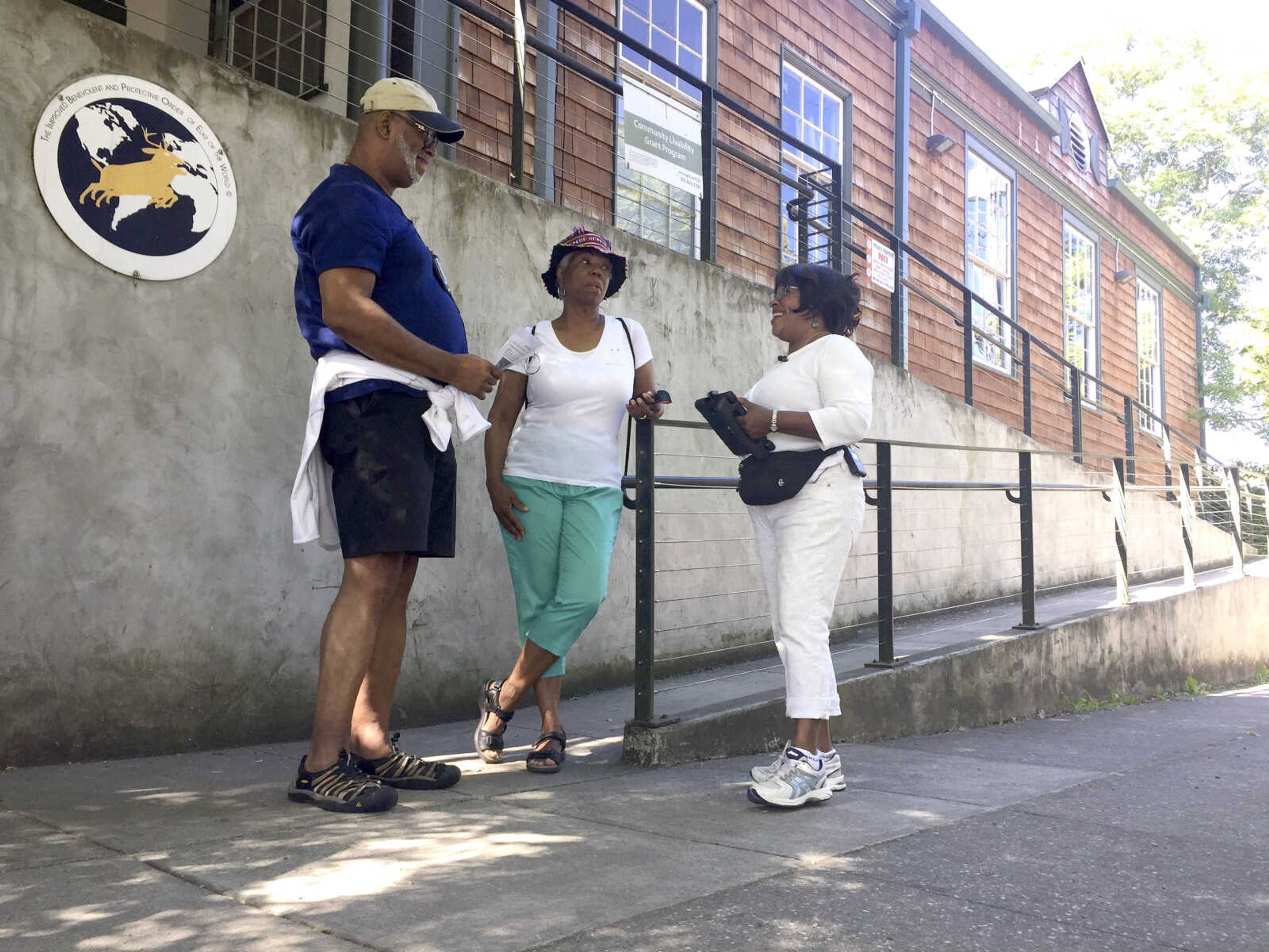 From left, Ron Young, Gahlena Easterly and Sharon Steen reminisce as they take a mile-long walk July 6 through North Portland, Oregon, streets that once were full of black-owned homes and businesses. Researchers are studying whether jogging memories where they were made can help African-American seniors stay sharp and slow early memory loss.